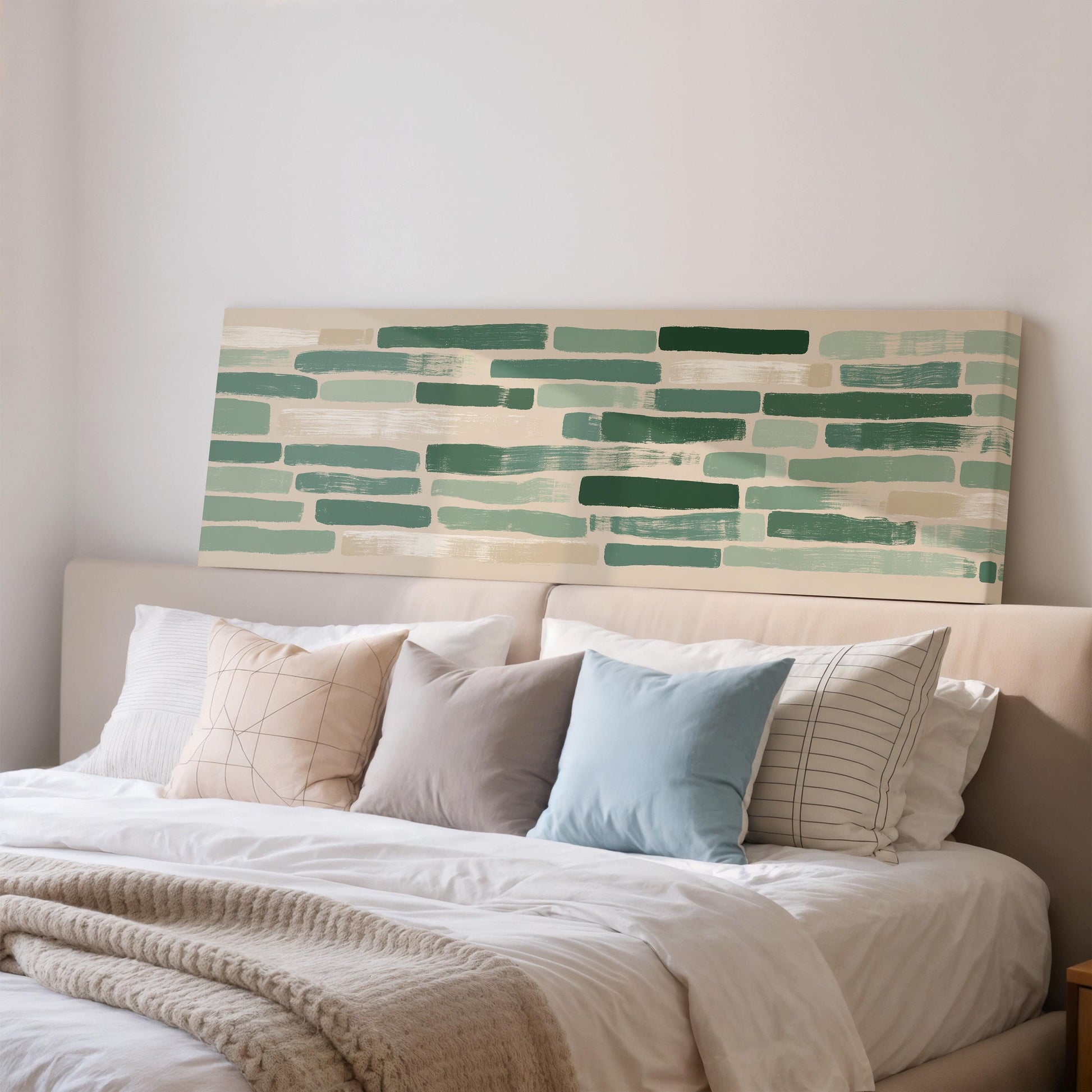 a cozy bedroom with a large bed adorned with a white comforter and a variety of colorful throw pillows. Above the bed, there is a large abstract painting featuring green and white stripes.