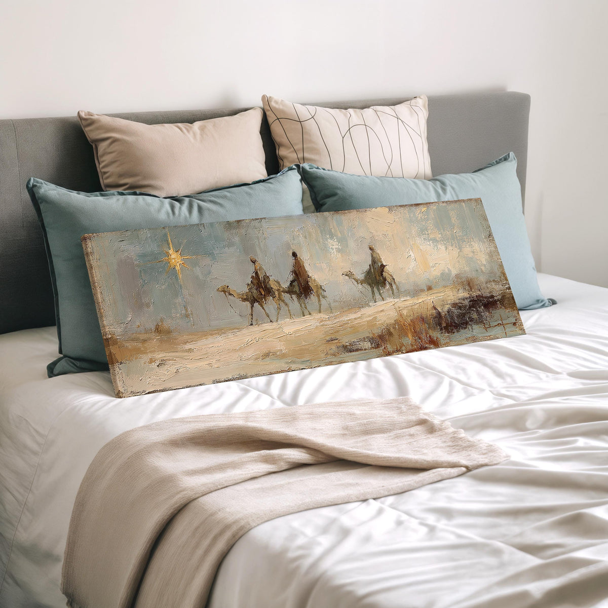 Wise men on camels following the star wide panoramic canvas print laid on a bed to show its size