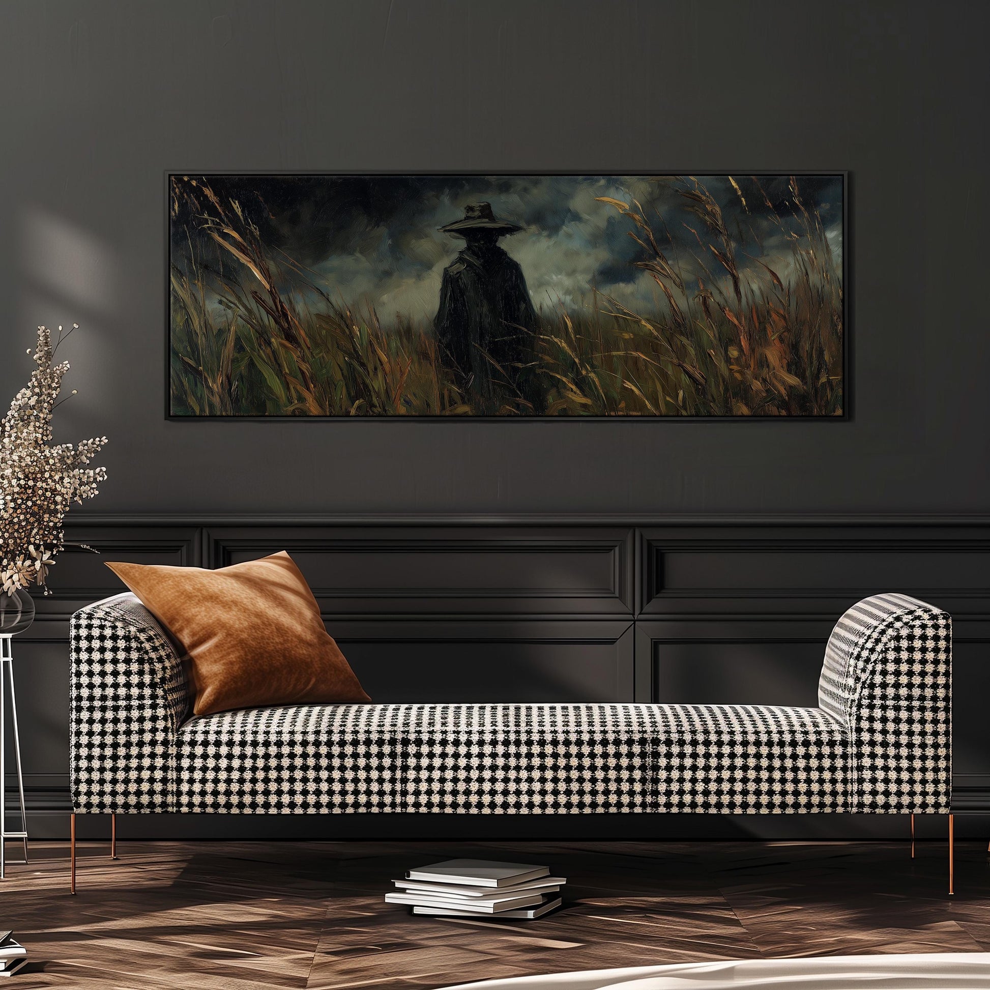 a black and white checkered sofa with a brown throw pillow, set against a dark wall with a large painting of a person in a field of tall grass hanging above it.