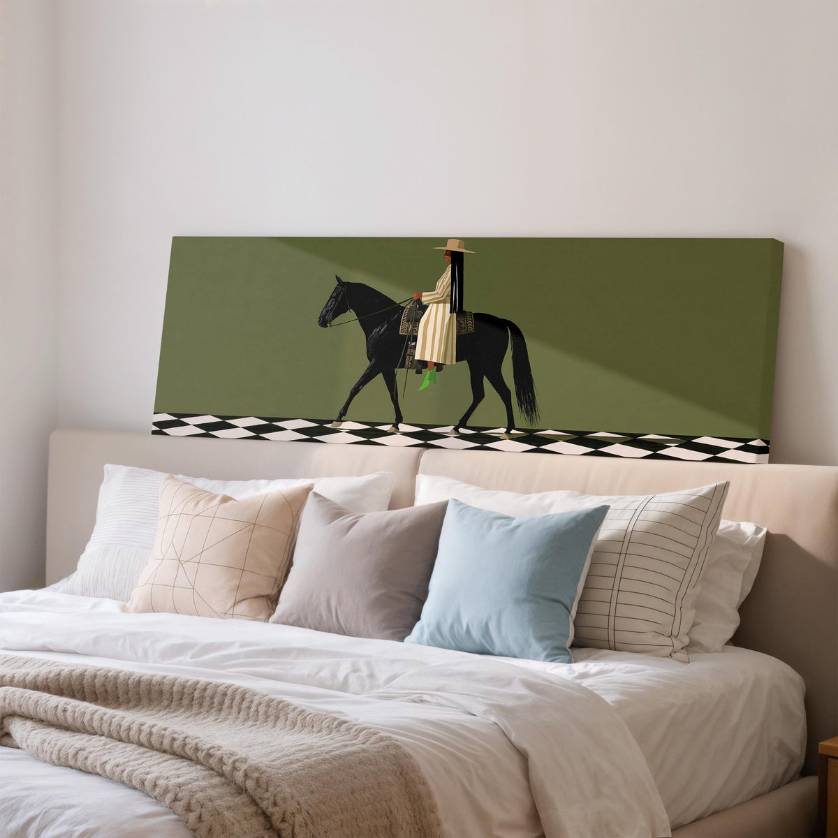 Woman riding a black horse on a checkerboard wide panoramic canvas print above a bed in a bedroom