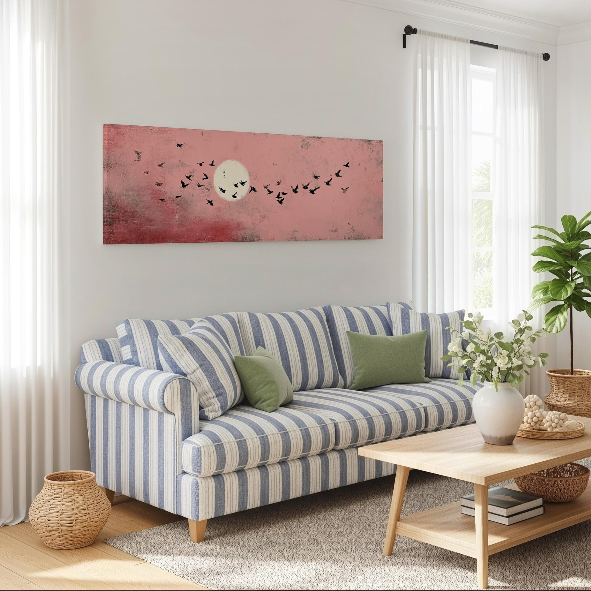 a cozy living room with a striped blue and white sofa, a wooden coffee table, and a large window with white curtains. Above the sofa, there is a large painting of a flock of birds against a pink and white background.
