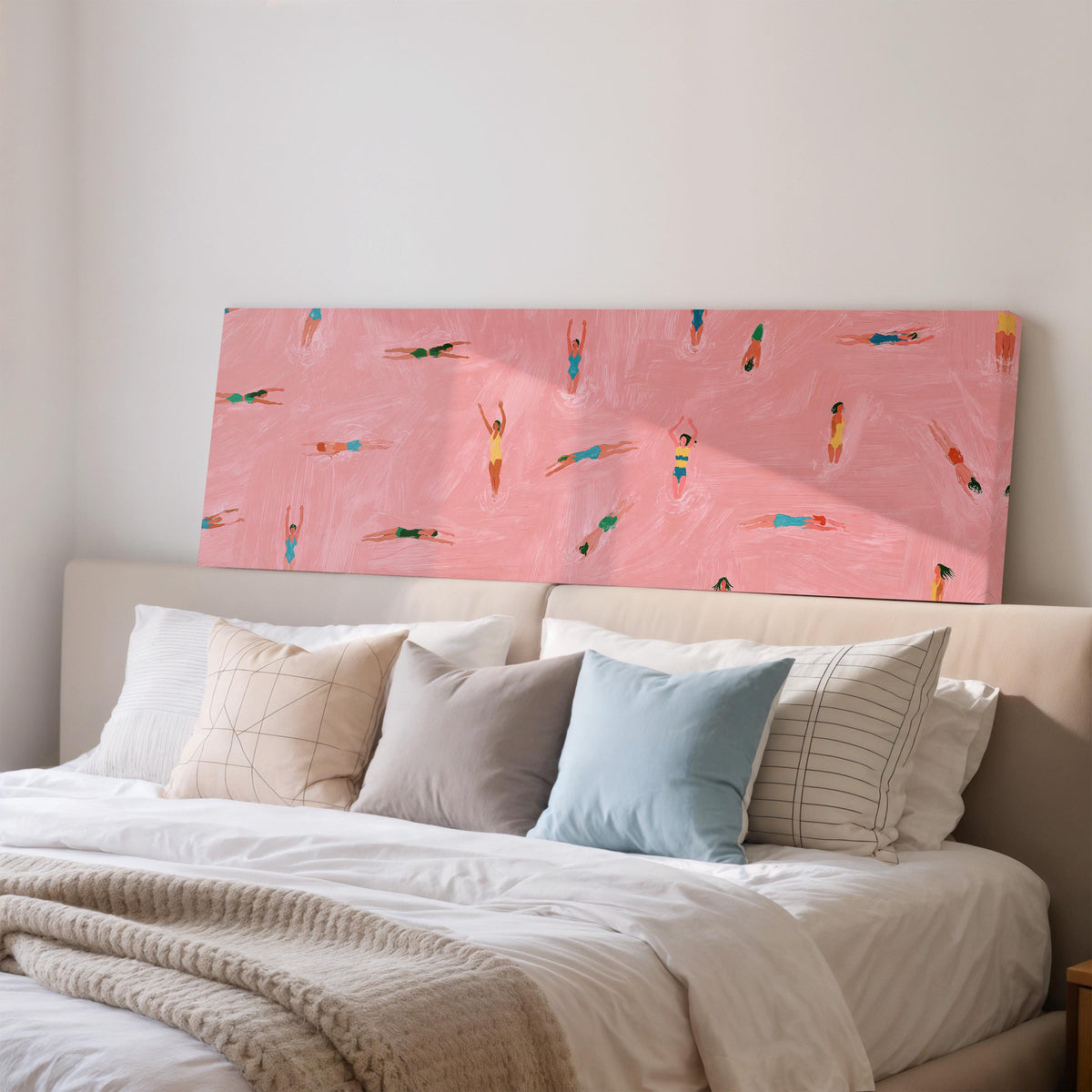 Tiny swimmers in a pink pool from above wide panoramic canvas print above a bed in a bedroom