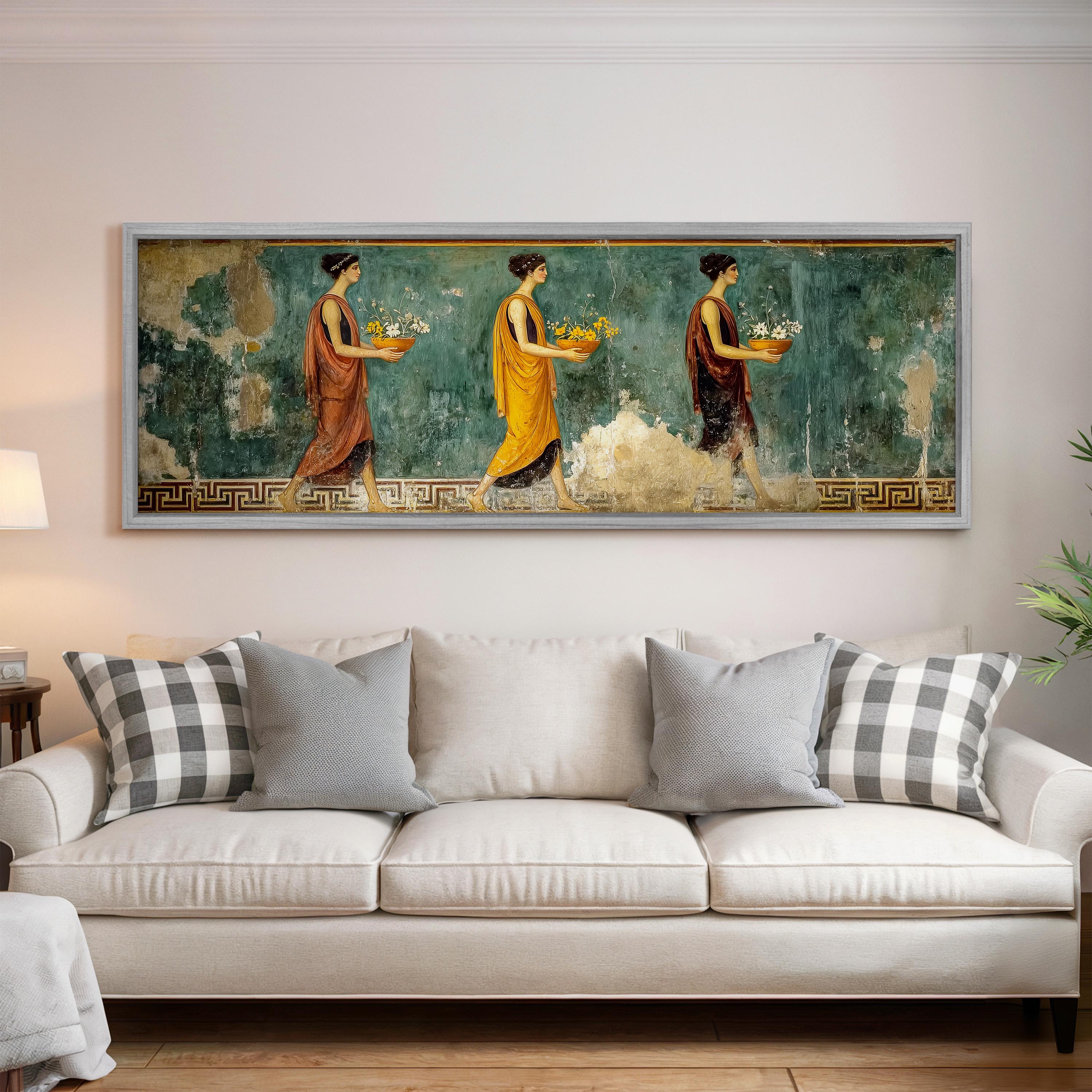 a large painting of three women in colorful dresses, each carrying a basket of fruit, displayed on a wall above a white couch in a living room setting.