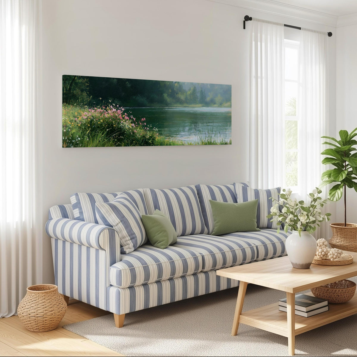 Pink wildflowers on a green lakeshore long horizontal canvas print above a striped sofa in a coastal living room