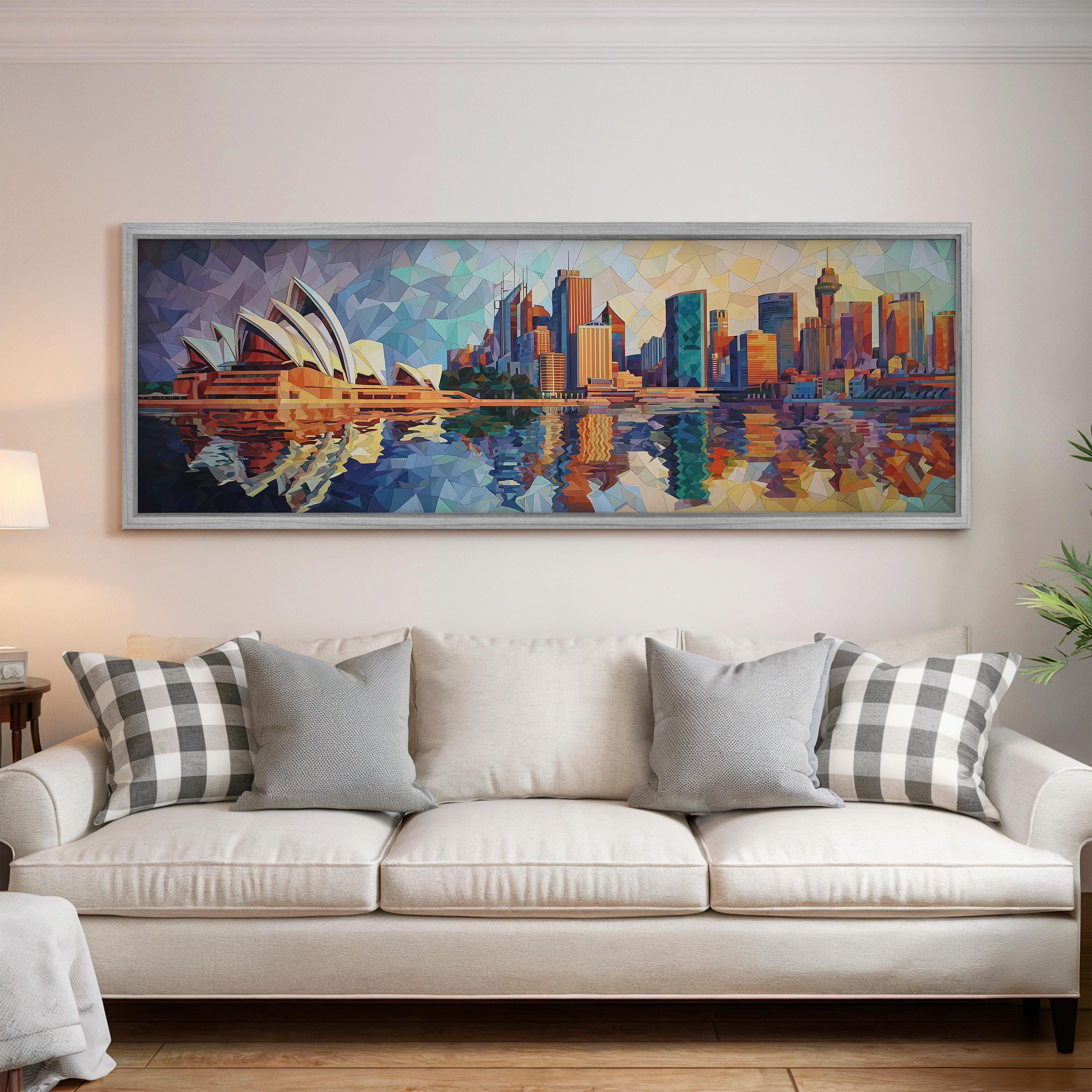 a large, colorful painting of the Sydney Opera House and the city skyline, hanging on a wall above a white couch with patterned throw pillows.