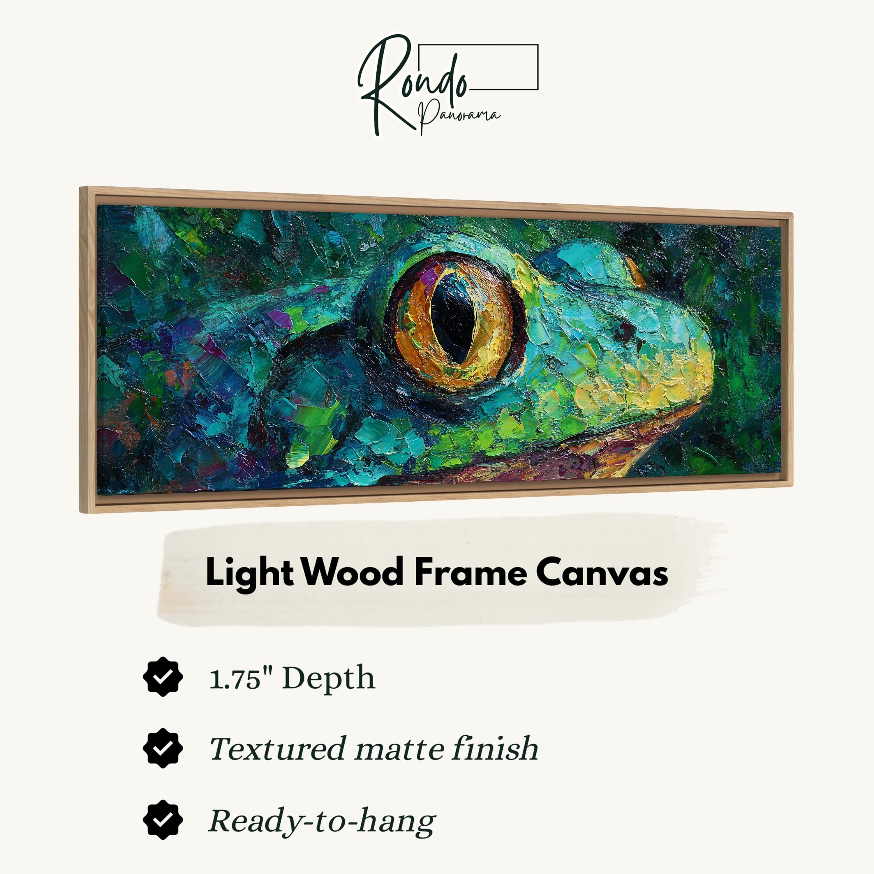 The image is a close-up of a vibrant, textured painting of a frog's eye, with a light wood frame.
