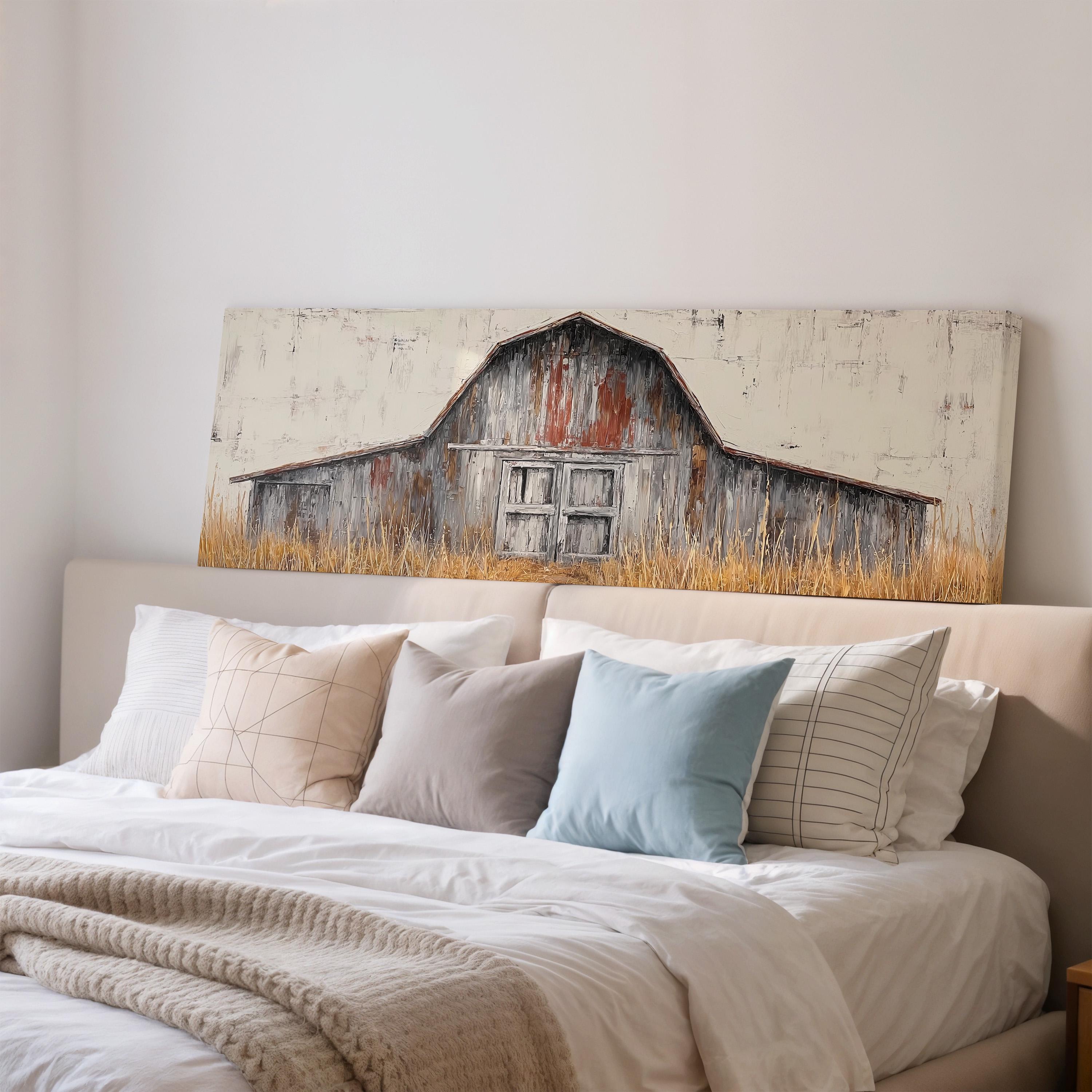 a bedroom with a large bed adorned with white linens and a blue pillow. Above the bed, there is a painting of a rustic barn with a weathered wooden exterior and a prominent door.