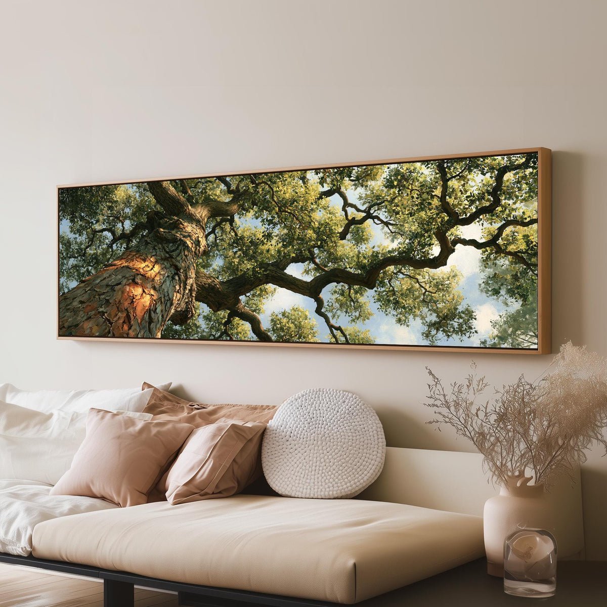 Ancient oak trunk and branches seen from below panoramic canvas print above a sofa in a living room