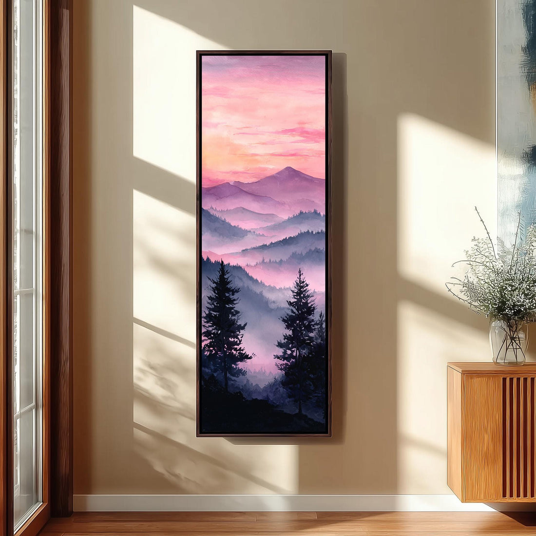 a large, framed painting of a mountain landscape with a colorful sunset sky, hanging on the wall of a hallway.