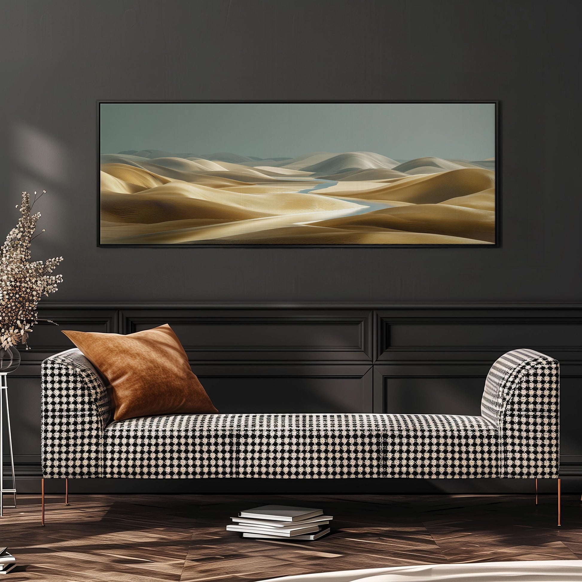 a modern living room with a black and white checkered sofa, a stack of books, and a large landscape painting hanging on the wall above the sofa.