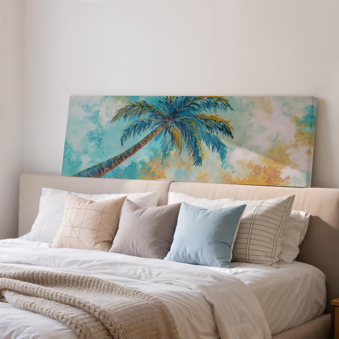 a large, framed painting of a palm tree hanging on a wall above a brown sofa.