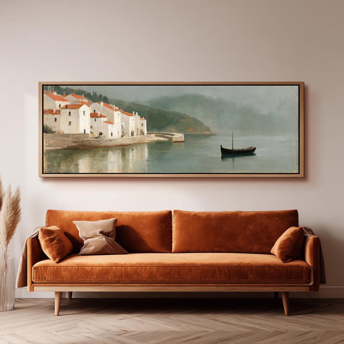 Whitewashed harbor village and a small boat long horizontal canvas print above a sofa in a living room