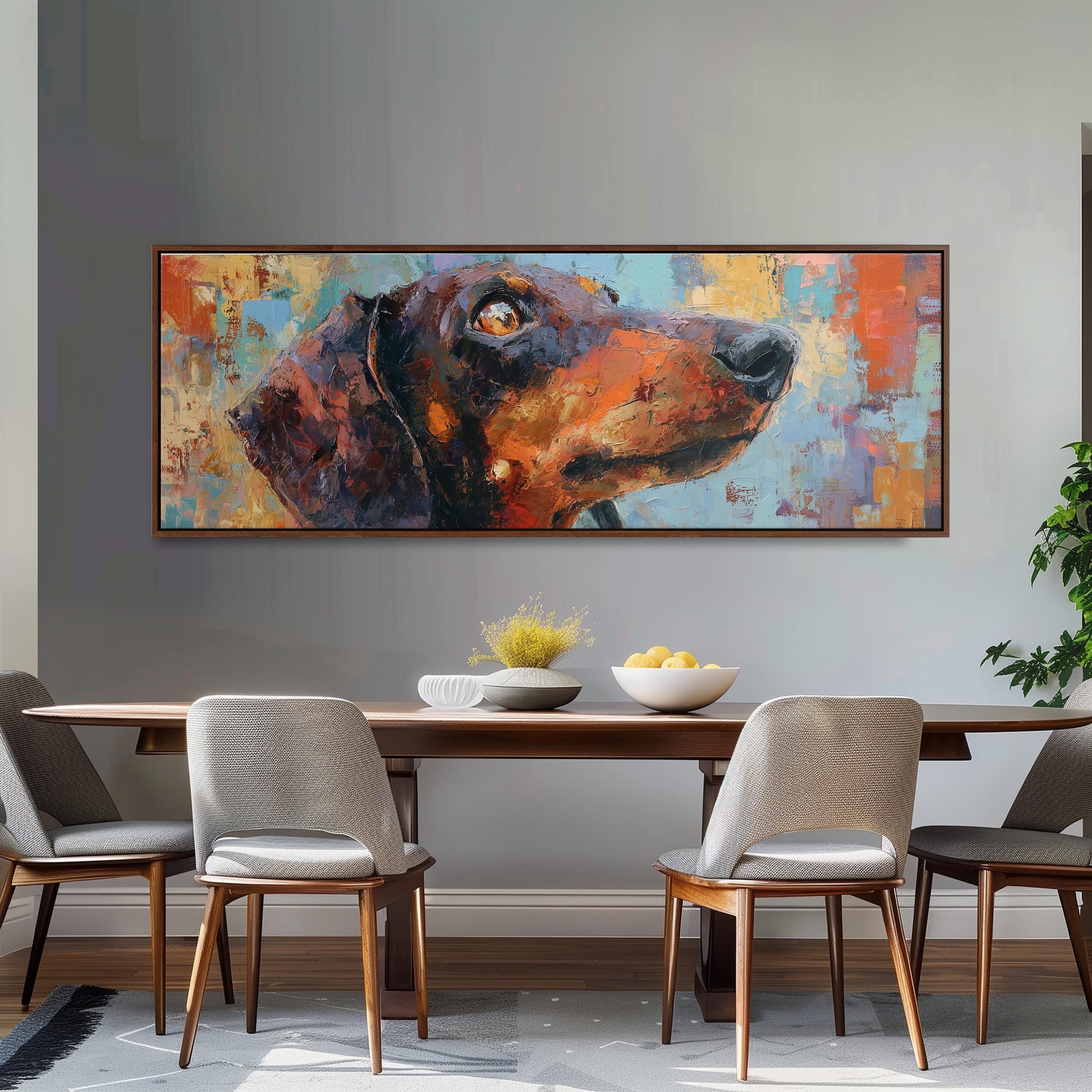 a large painting of a dog's head hanging on a wall above a wooden dining table with four chairs.