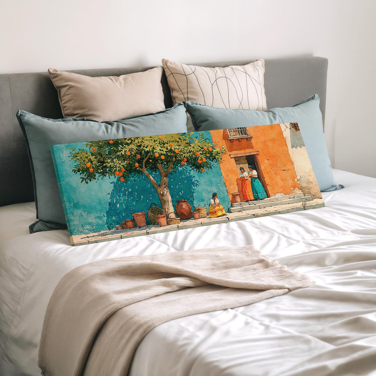 Orange tree on a colorful village street wide panoramic canvas print laid on a bed to show its size