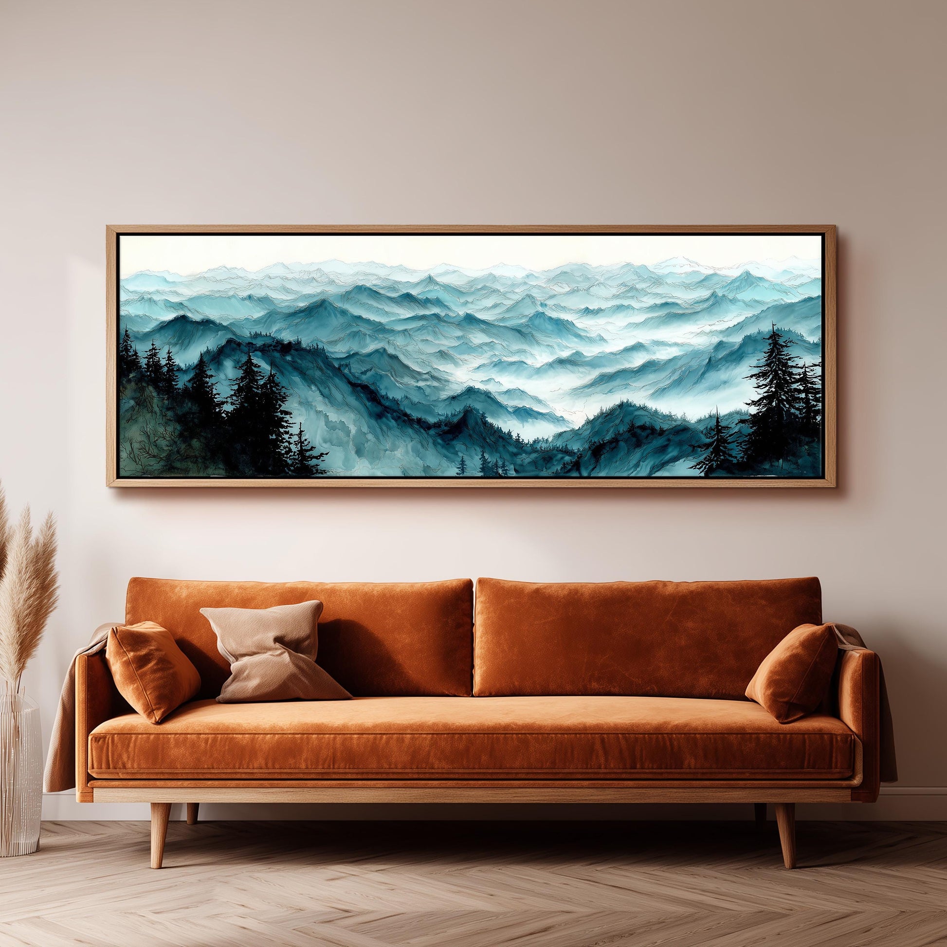 a large, framed painting of a mountainous landscape hanging on a wall above a brown sofa.