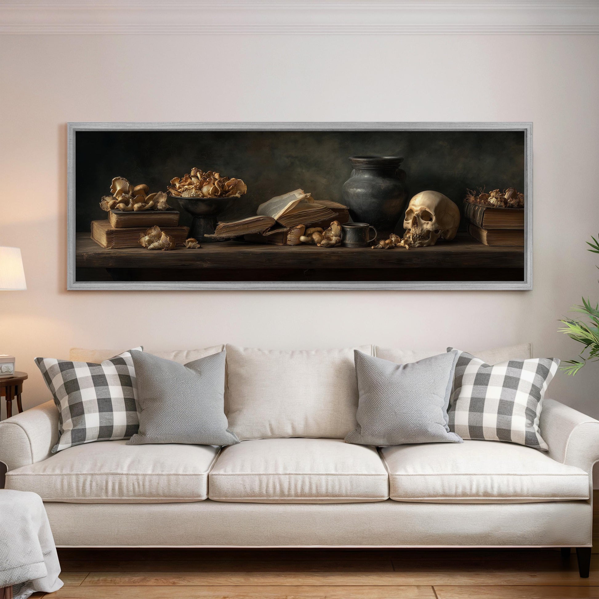 a large painting of a still life arrangement on a wall above a white sofa with patterned throw pillows.