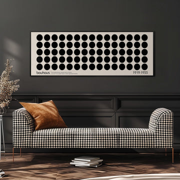 a modern living room with a black and white checkered sofa, a stack of books, and a large abstract art piece on the wall.