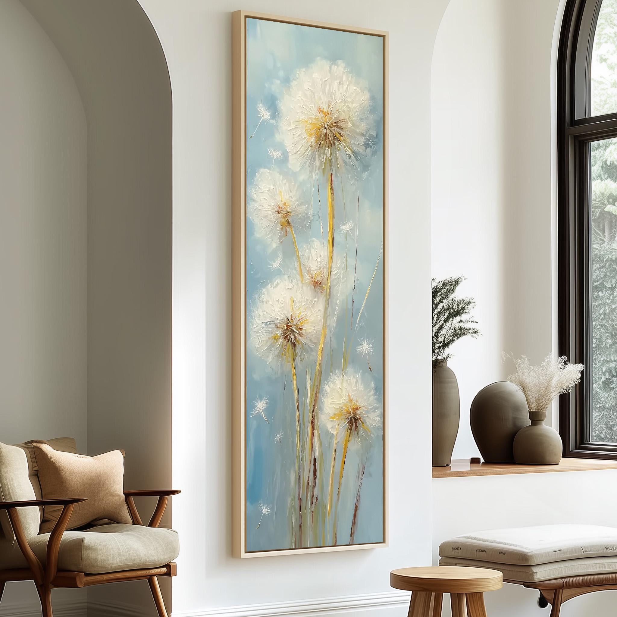 a large painting of dandelions hanging on a wall in a room with a wooden chair, a small table, and a window with a plant on the sill.