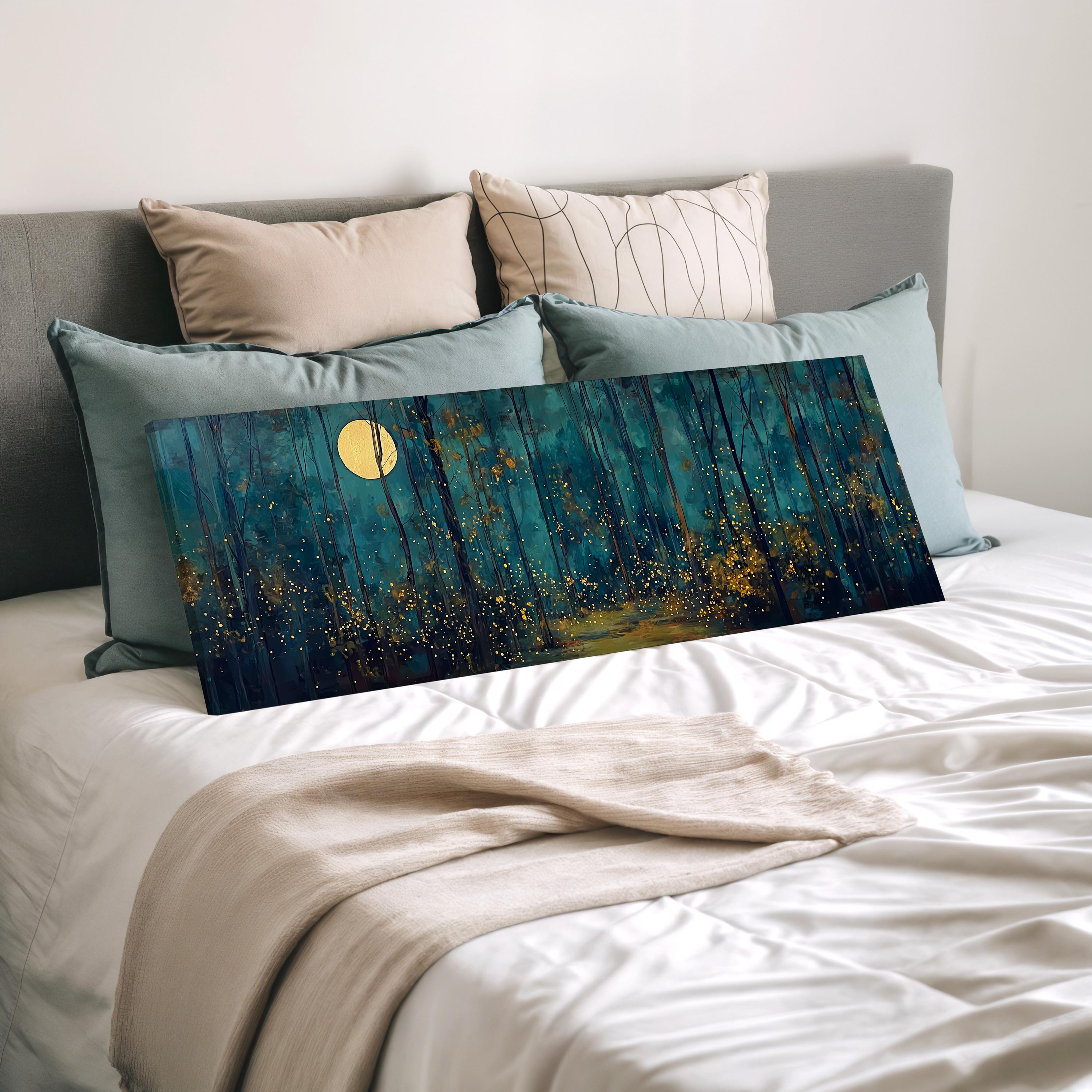 a large, rectangular painting of a forest scene with a full moon in the background, displayed on a bed with white bedding.