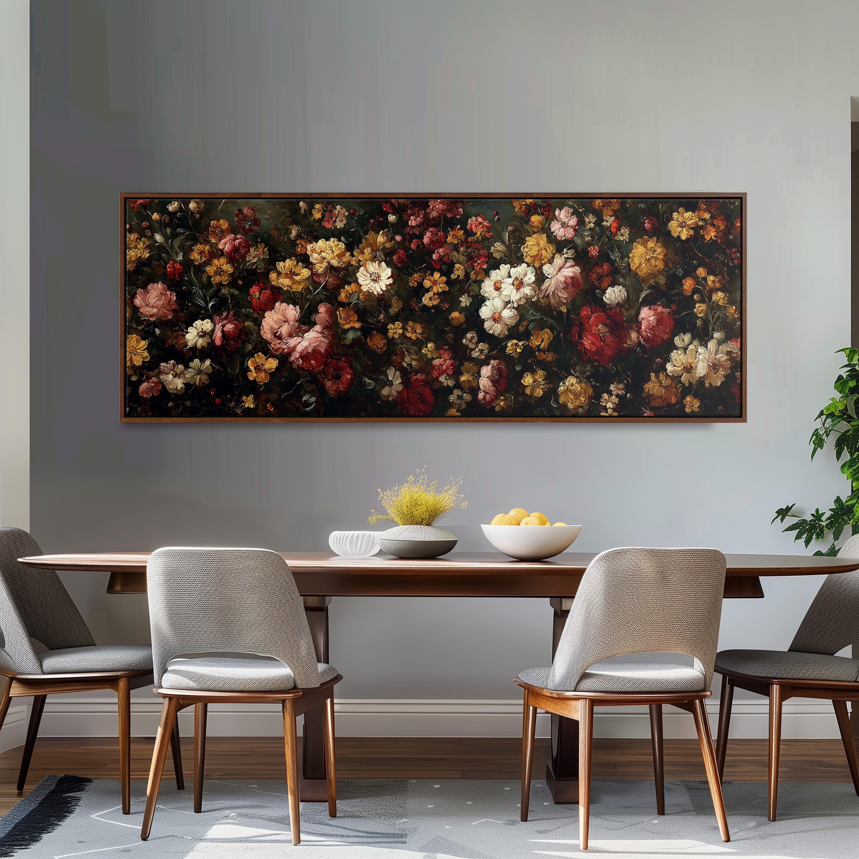 a dining room with a large floral painting hanging on the wall above a wooden table with four chairs. The table is set with a bowl of fruit and a vase of flowers, creating a cozy and inviting atmosphere.