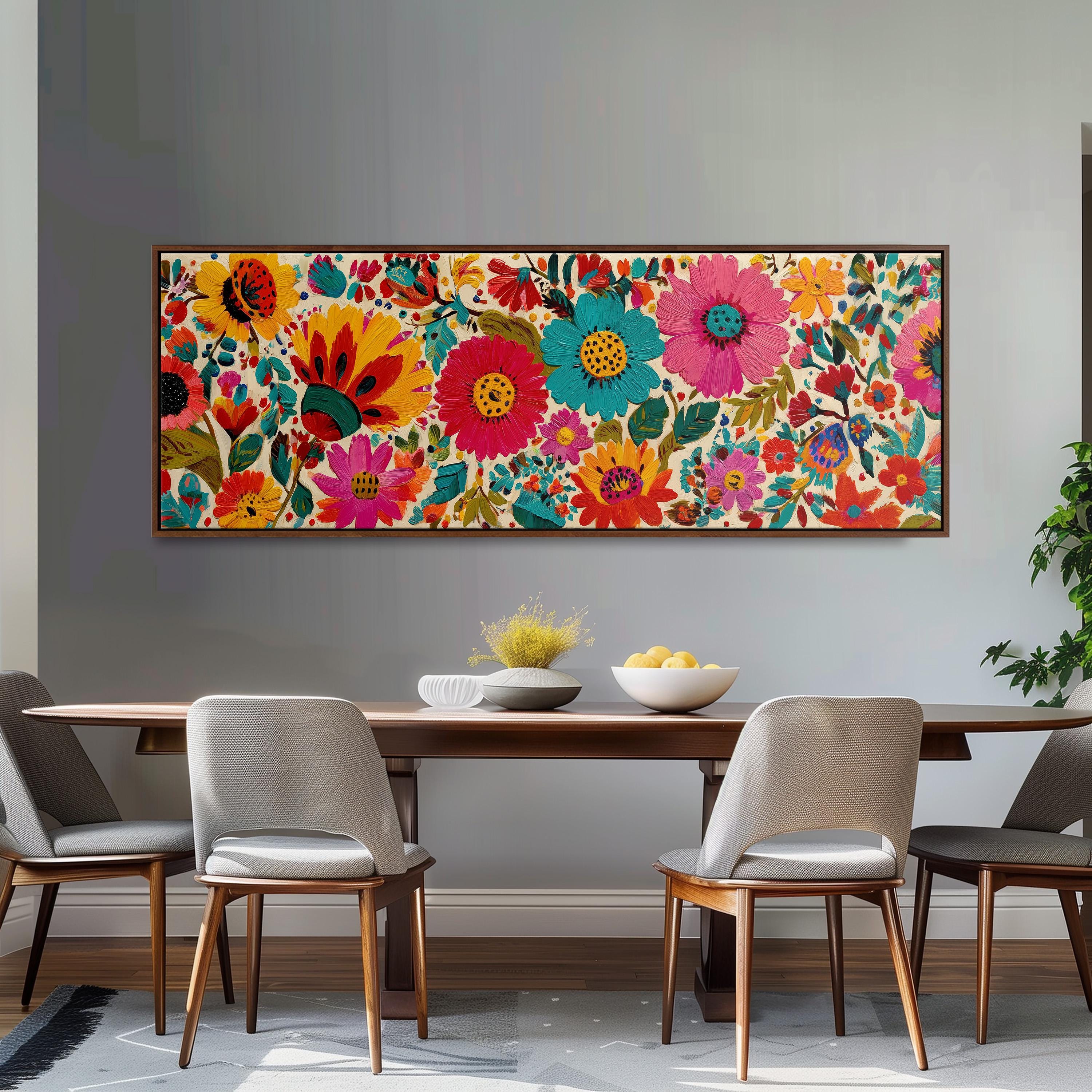 a dining room with a large, colorful floral painting hanging on the wall above a wooden dining table. The table is set with a bowl of fruit and a vase of flowers, creating a welcoming and vibrant atmosphere.