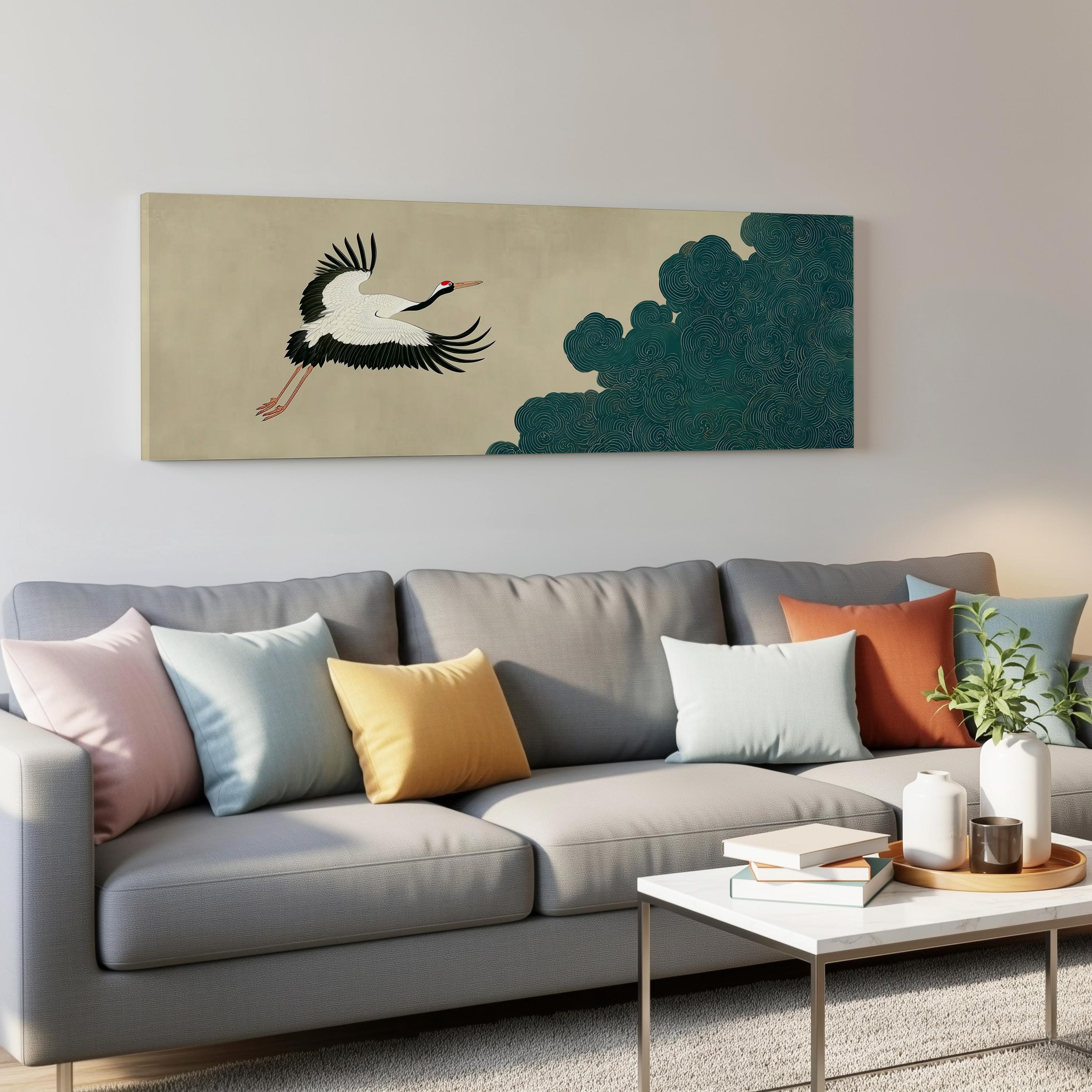 a gray couch with colorful throw pillows, a coffee table, and a large wall art depicting a crane in flight.