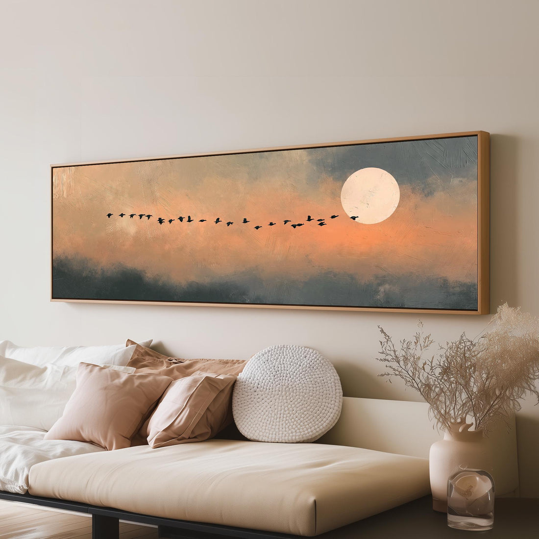 Geese flying toward the moon at twilight long horizontal canvas print above a sofa in a living room