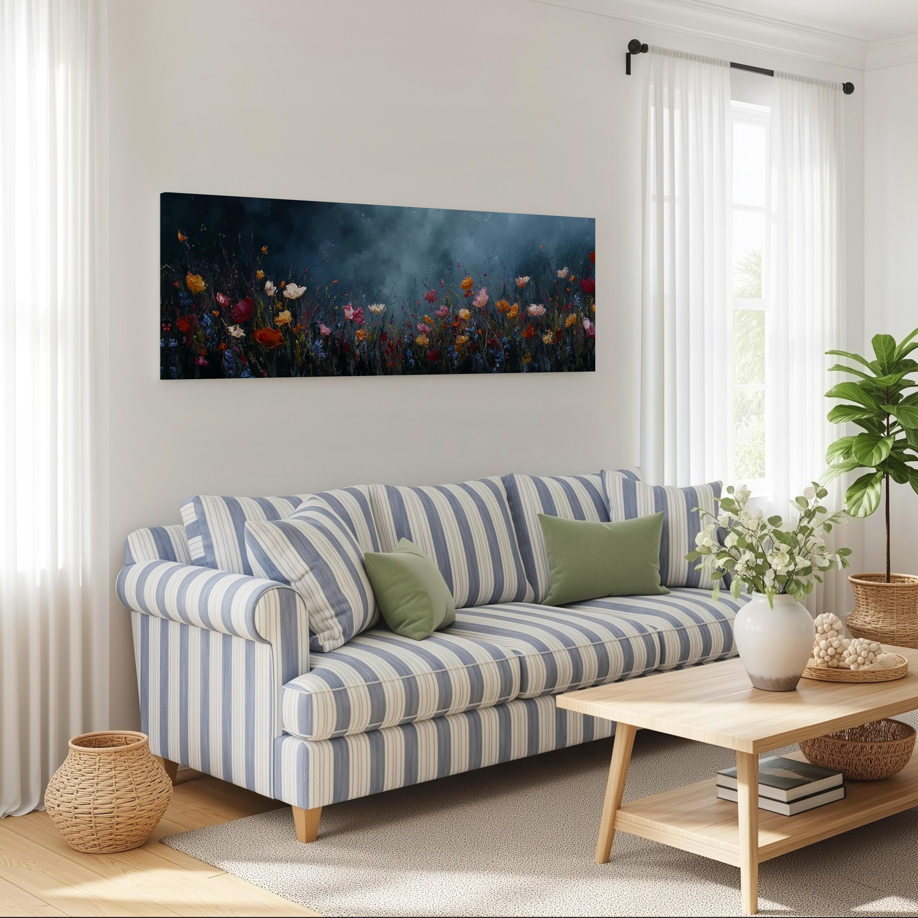 a cozy living room with a striped blue and white sofa, a wooden coffee table, and a large window with white curtains. Above the sofa, there is a large painting of a field of colorful flowers.