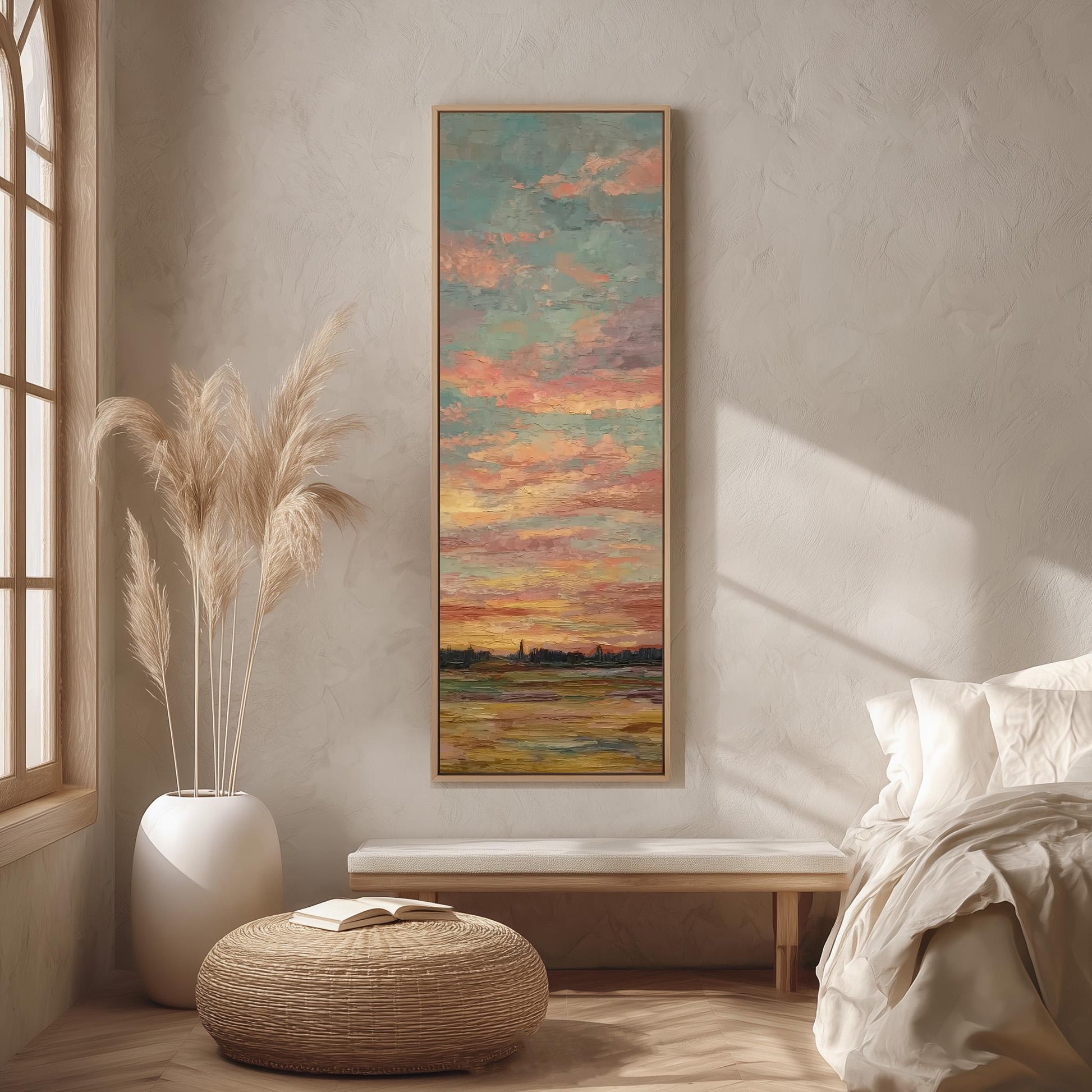 a serene bedroom scene with a large painting of a sunset over a body of water hanging on the wall. The painting is framed in a wooden frame and is the focal point of the room. The room features a bed with white bedding, a wicker ottoman, and a potted plant. The overall color scheme of the room is neutral, with pops of color from the painting and the potted plant.