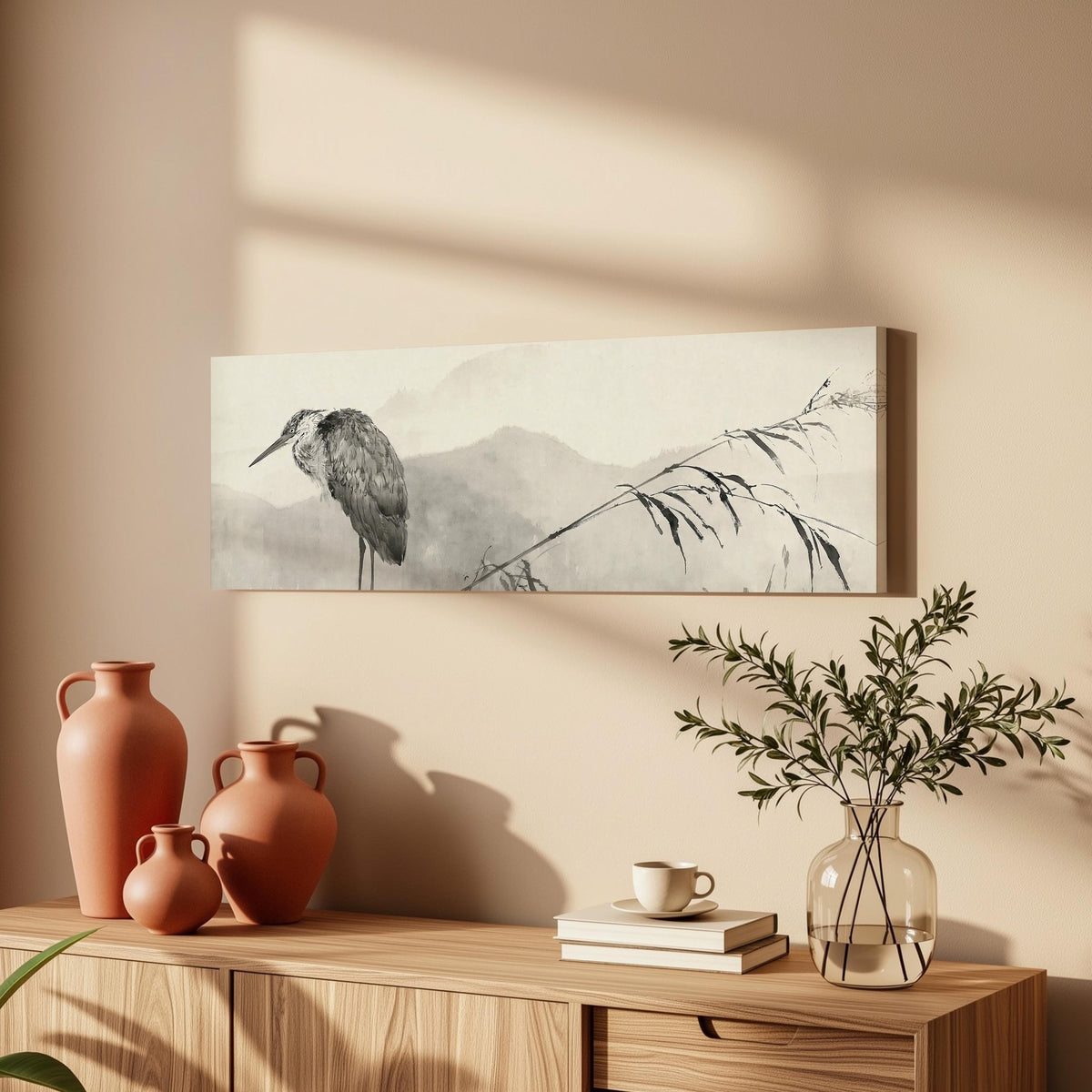 Heron in front of misty ink mountains long horizontal canvas print above a wooden sideboard