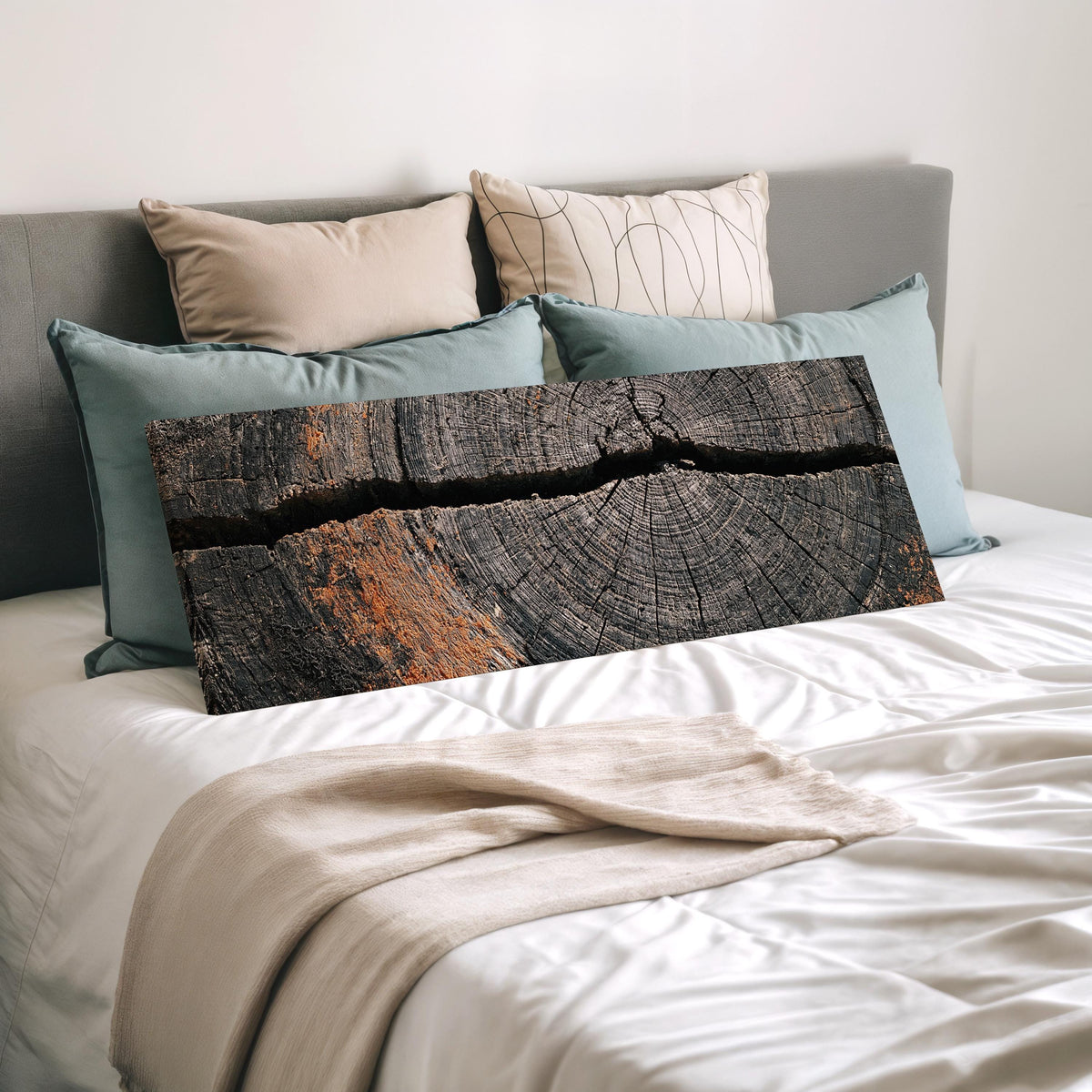 Cracked weathered wood ring wide panoramic canvas print laid on a bed to show its size