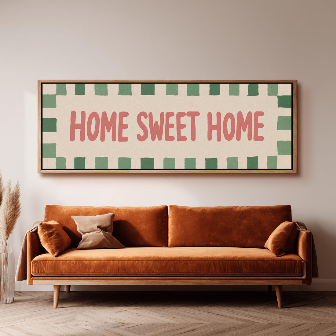 Home sweet home sign with a checked border long horizontal canvas print above a sofa in a living room