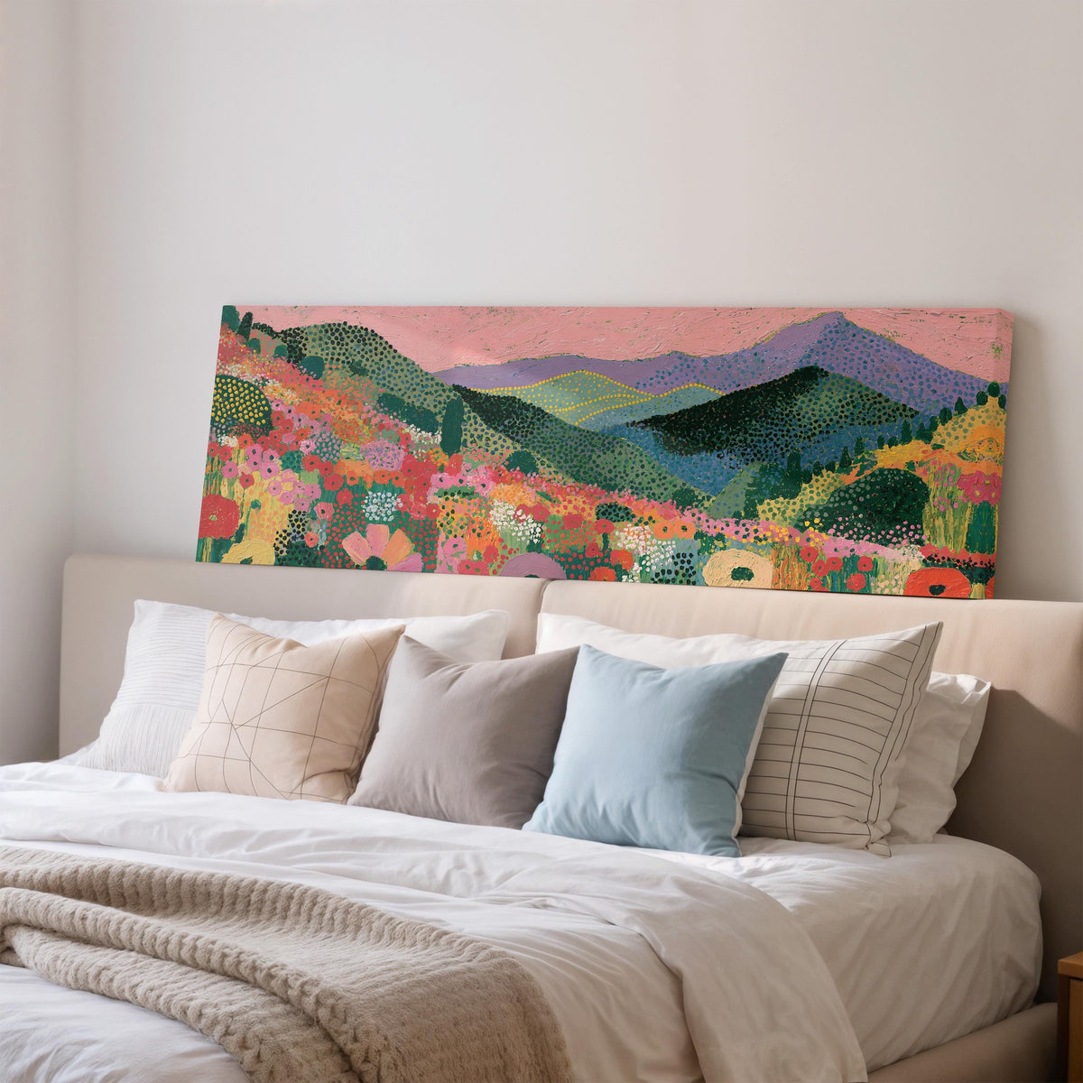 Purple mountains over a flower meadow wide panoramic canvas print above a bed in a bedroom