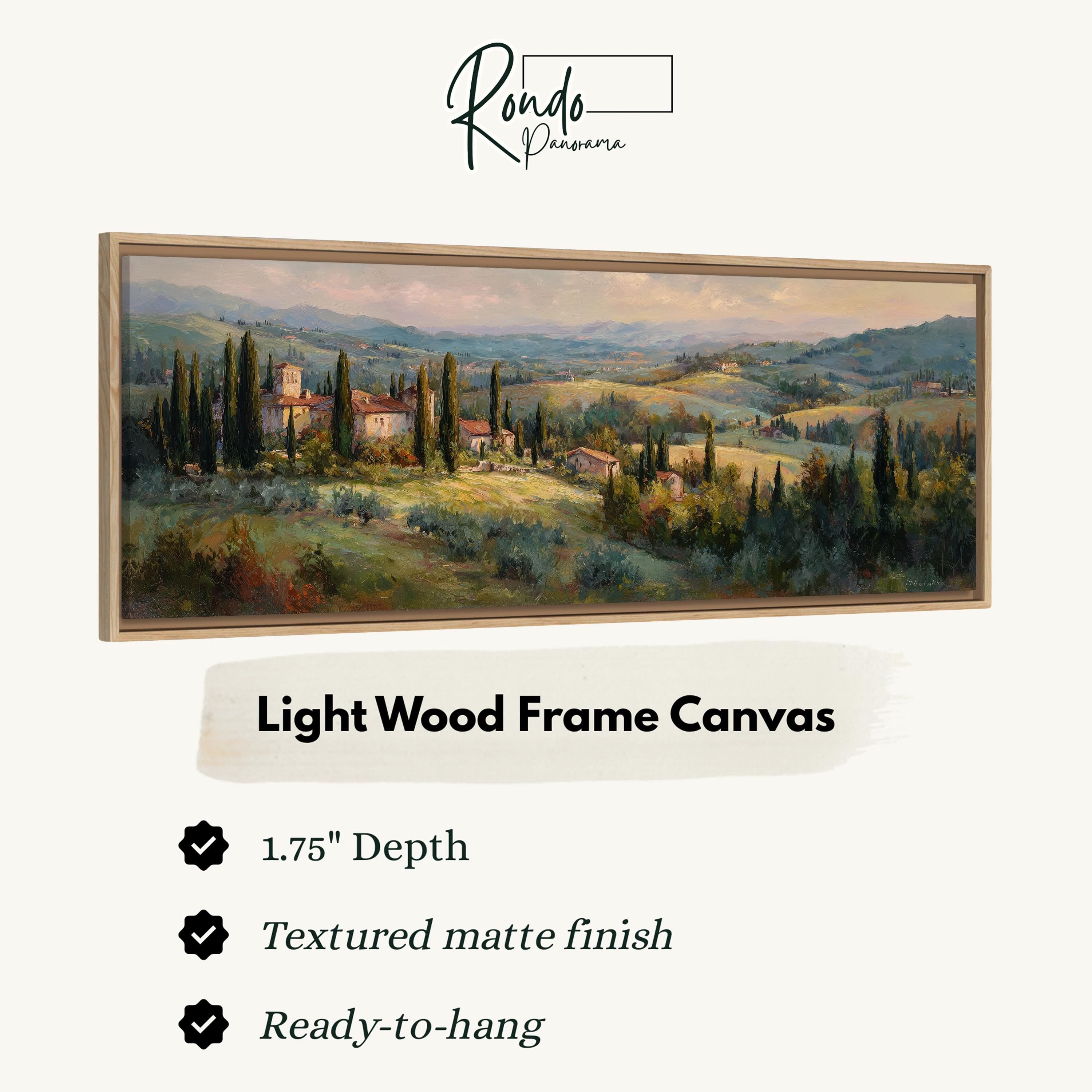 The image is a light wood frame canvas depicting a picturesque countryside landscape with rolling hills, trees, and buildings.