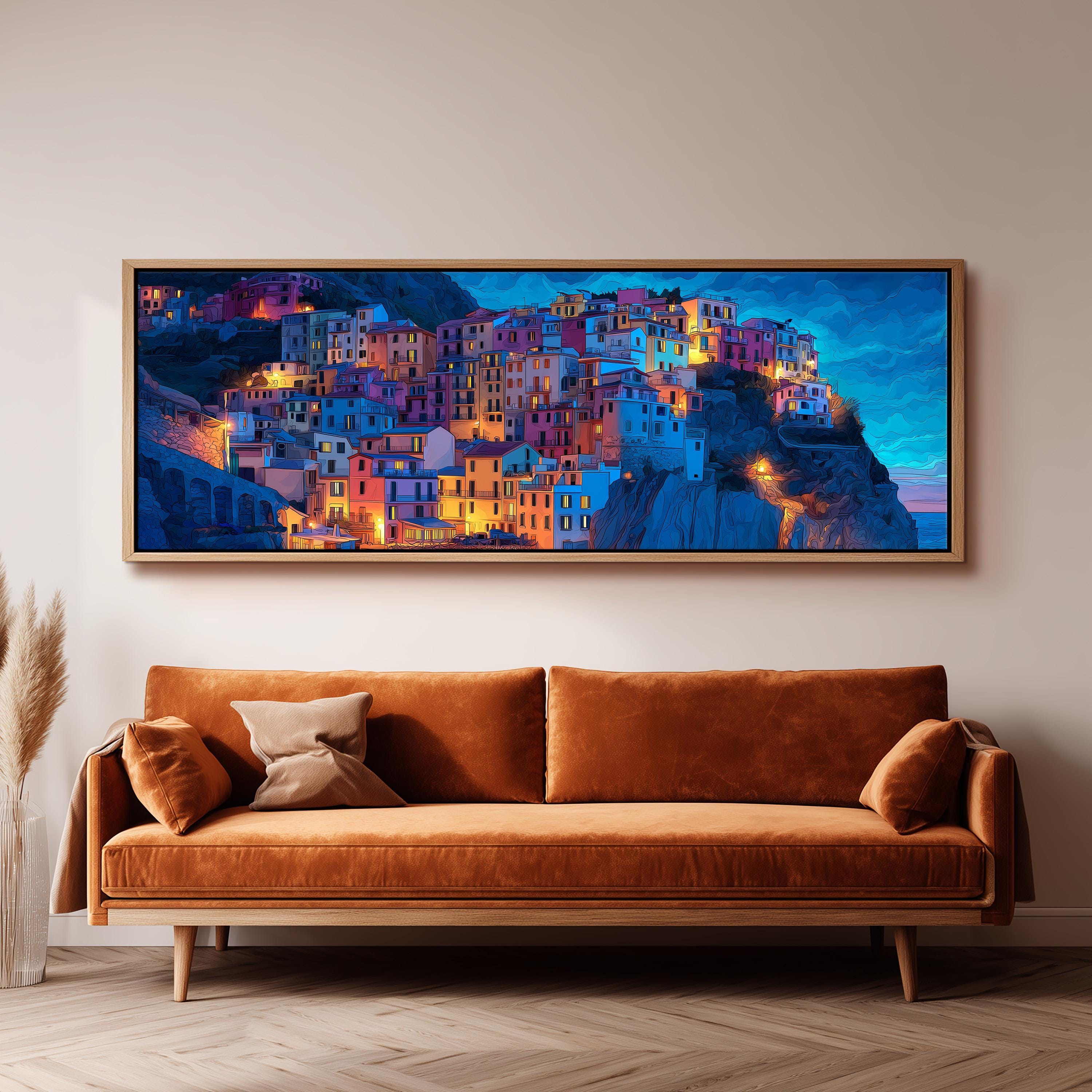 a large, colorful painting of a town on a cliff, hanging on a wall above a brown sofa.