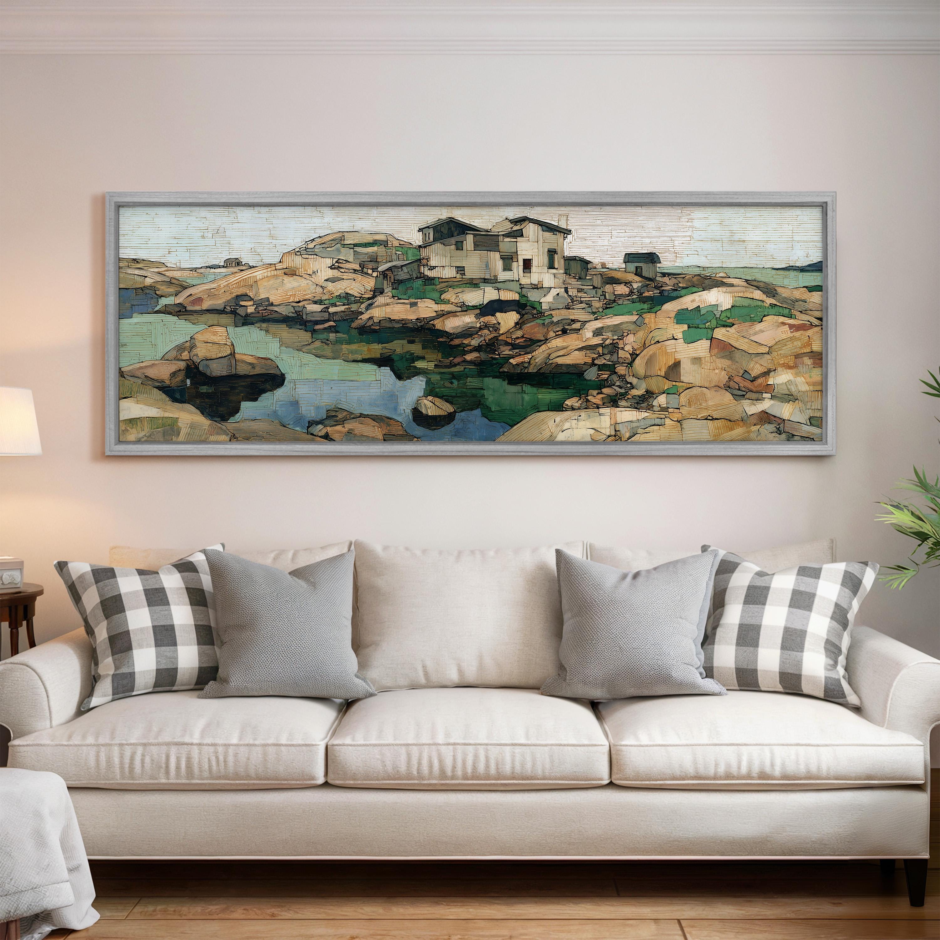 a large framed painting of a landscape with a house and a body of water, hanging on a wall above a white sofa with patterned throw pillows.