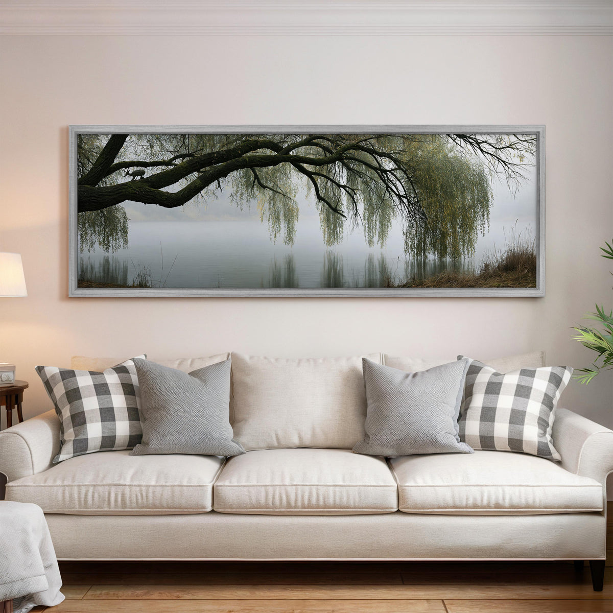Weeping willow over a misty lake panoramic canvas print above a white sofa in a bright living room