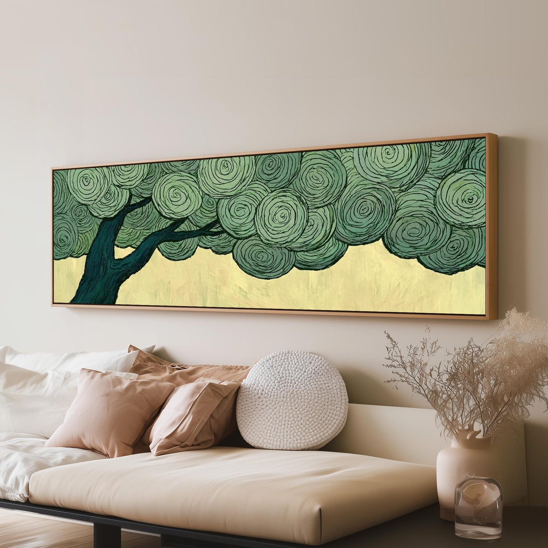 Tree with a swirling green canopy long horizontal canvas print above a sofa in a living room