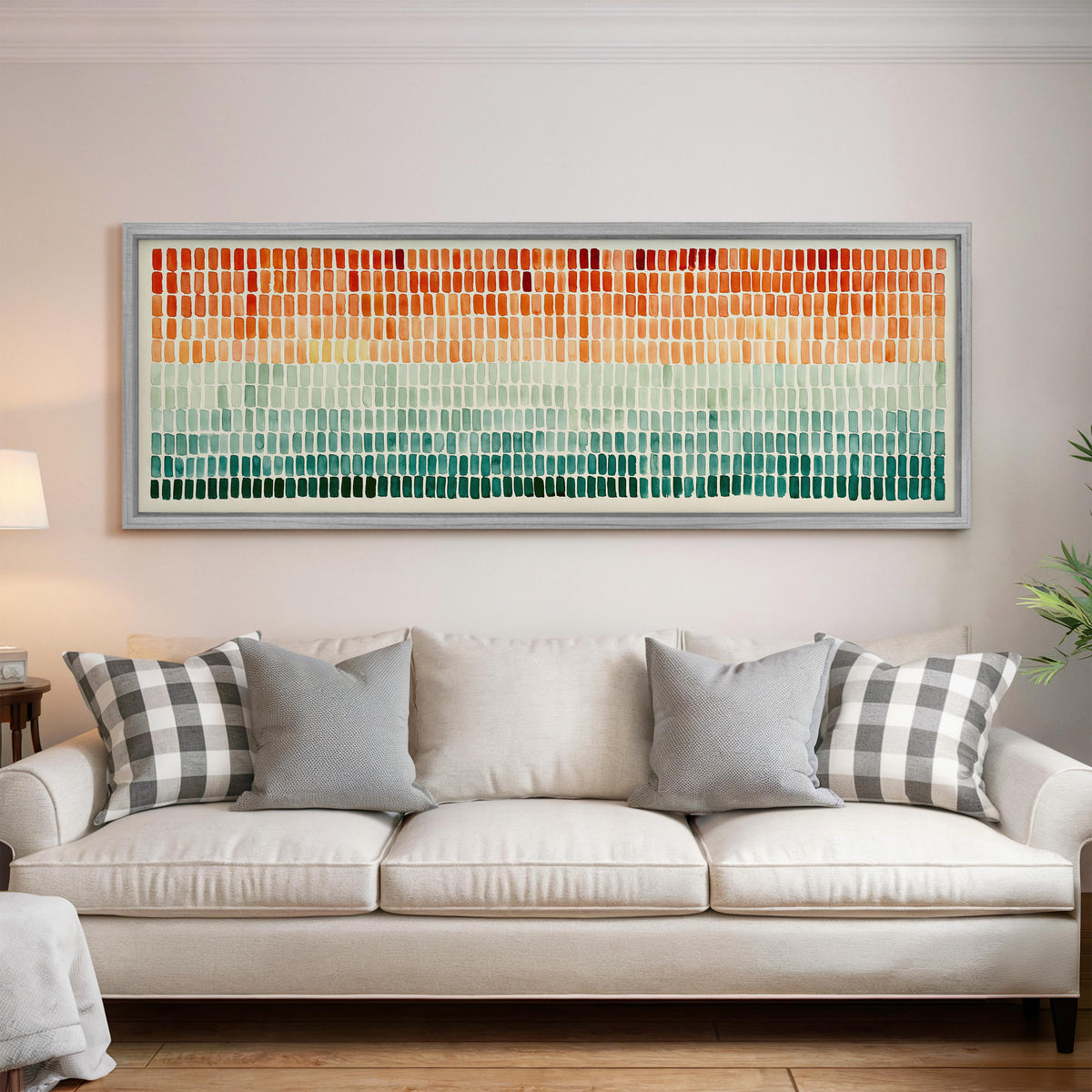 Brushmarks fading from orange to teal panoramic canvas print above a white sofa in a bright living room