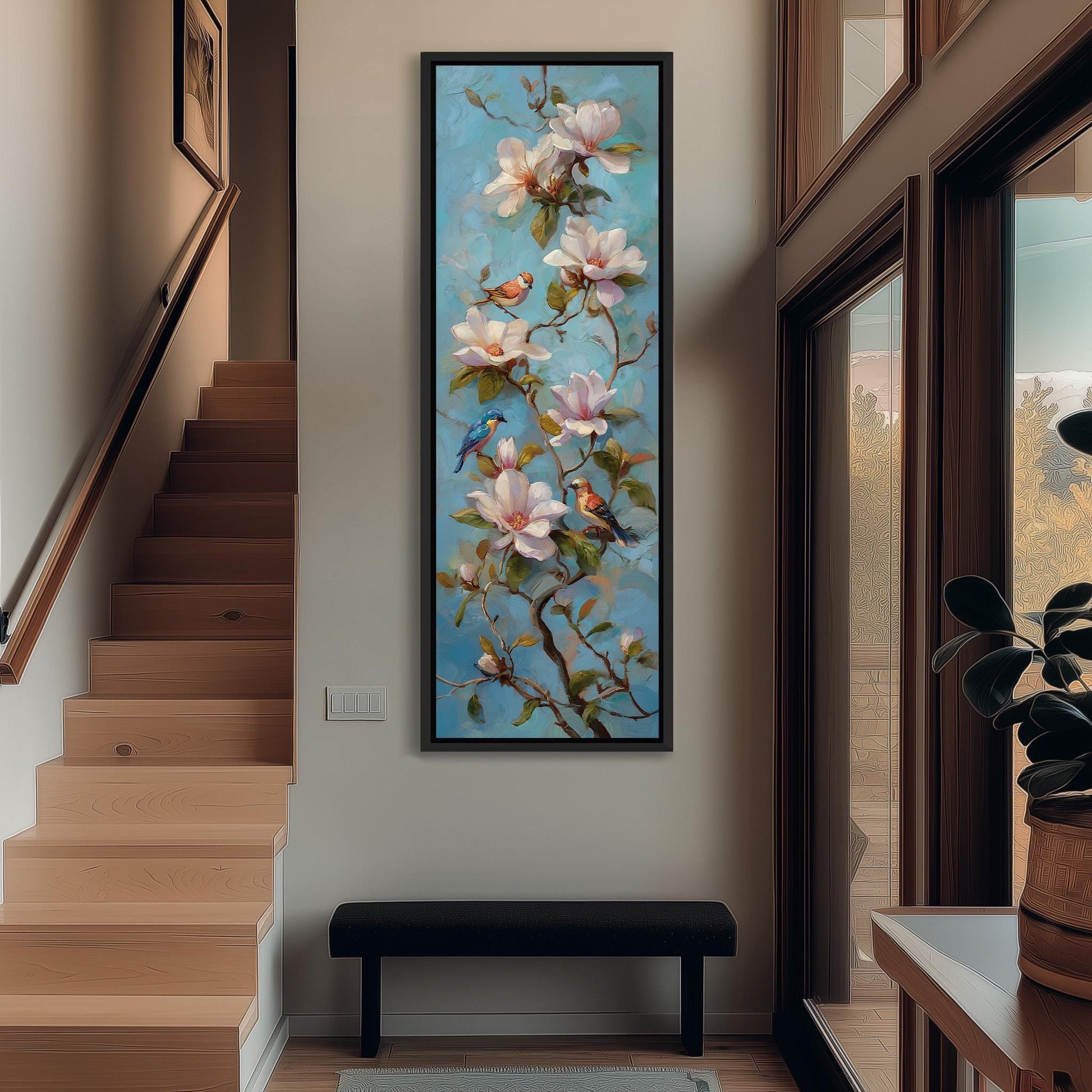 a large painting of a tree with pink flowers hanging on the wall, situated in a hallway with a staircase and a bench.