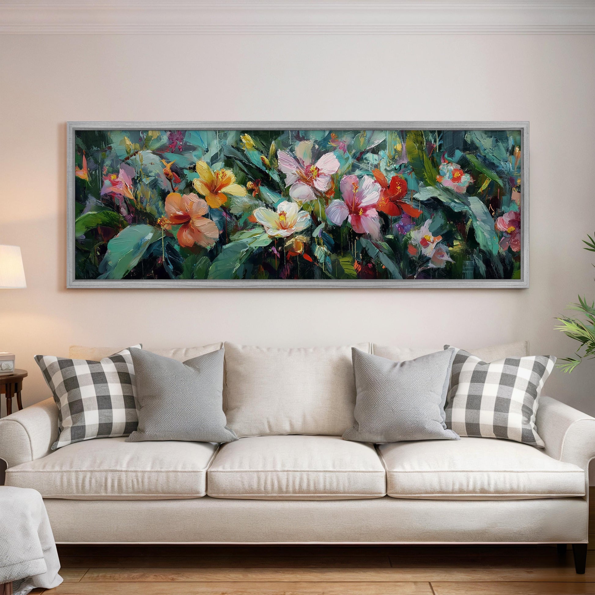a large, colorful painting of flowers hanging on a wall above a white couch with gray and white plaid throw pillows.