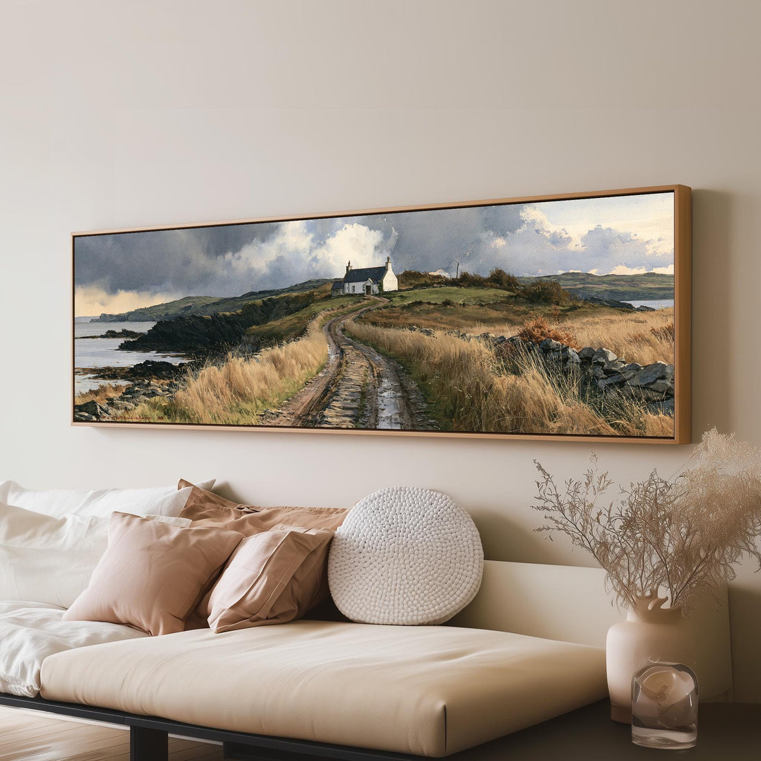 Dirt road to a coastal cottage under dramatic clouds long horizontal canvas print above a sofa in a living room