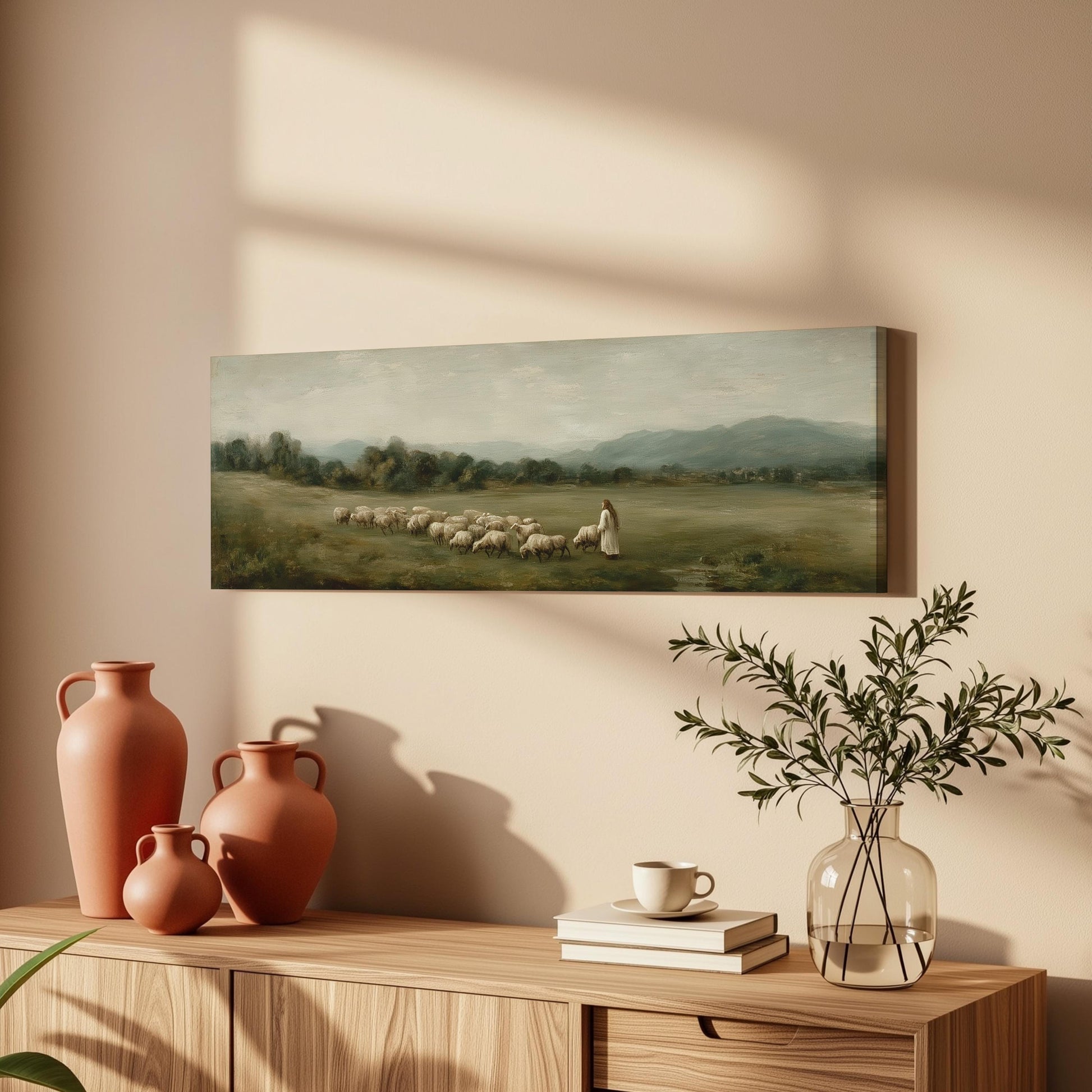 a painting of a pastoral scene with a woman herding sheep in a field, accompanied by a vase of greenery and a stack of books on a wooden table.