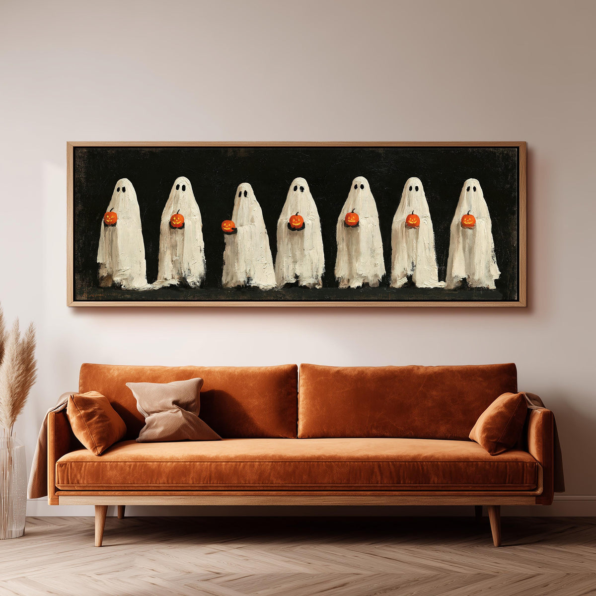 Row of ghosts holding pumpkins wide panoramic canvas print above a bench in a dark living room