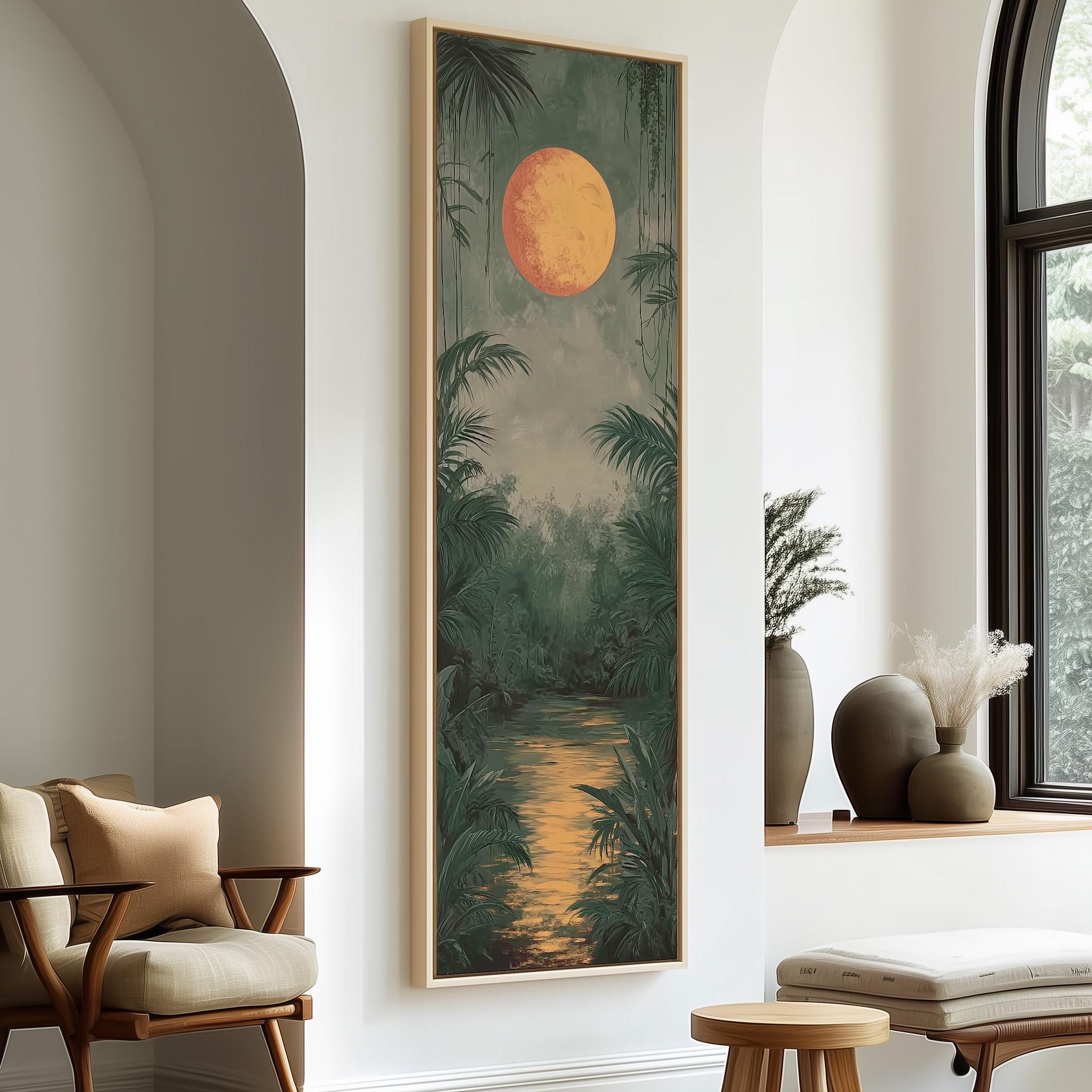 a large painting of a tropical landscape with a large orange sun in the sky, surrounded by lush greenery and a winding river. The painting is hung on a white wall, and there are two chairs and a small table in the foreground.