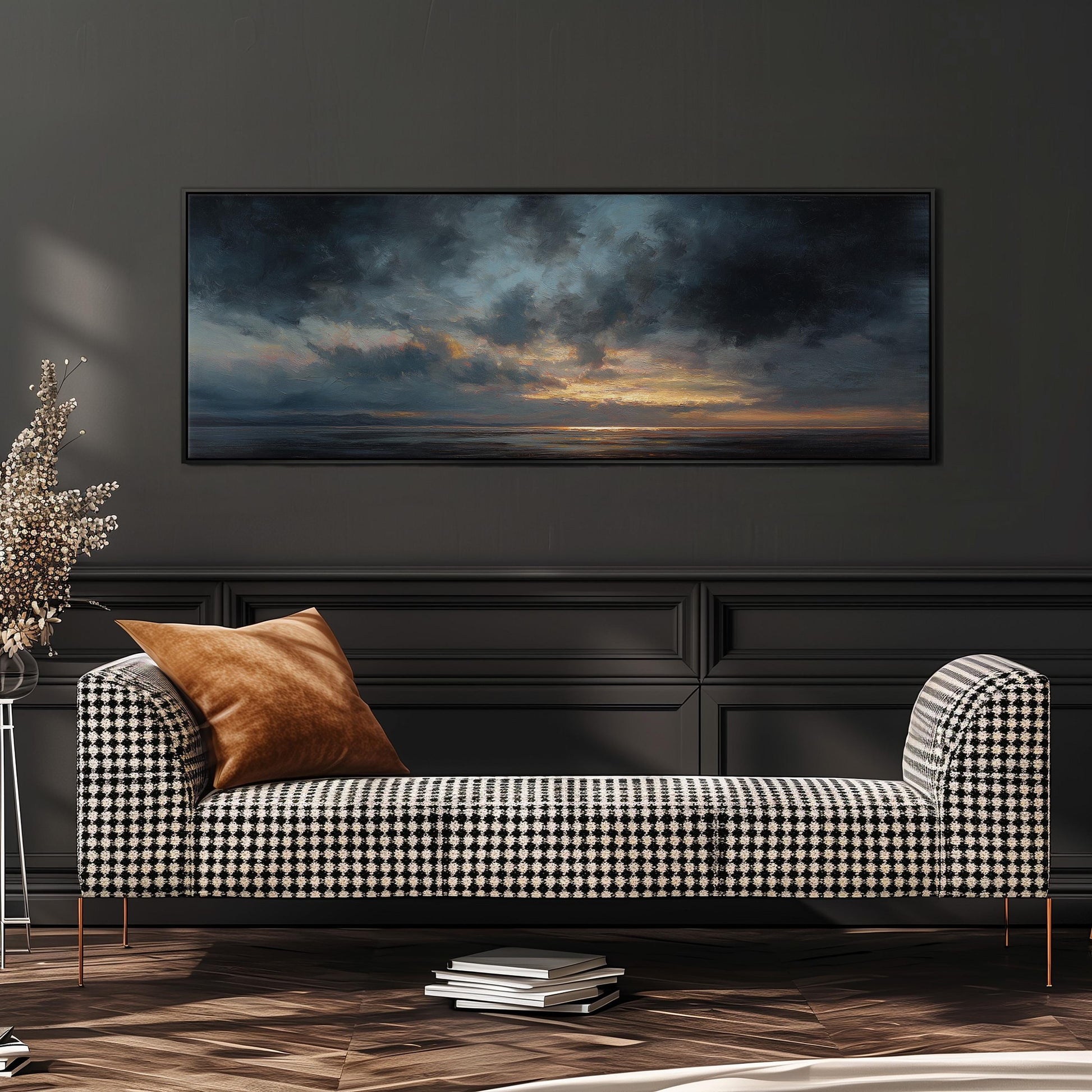 a black and white checkered sofa with a brown throw pillow, positioned in front of a large painting depicting a serene landscape with a cloudy sky and a sunset.