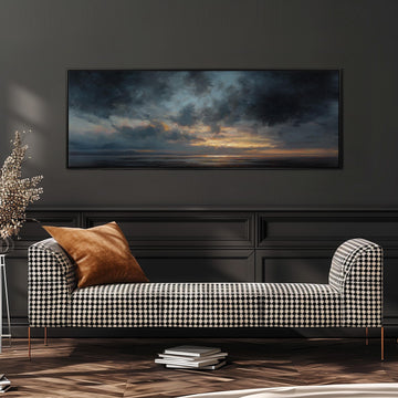 a black and white checkered sofa with a brown throw pillow, positioned in front of a large painting depicting a serene landscape with a cloudy sky and a sunset.