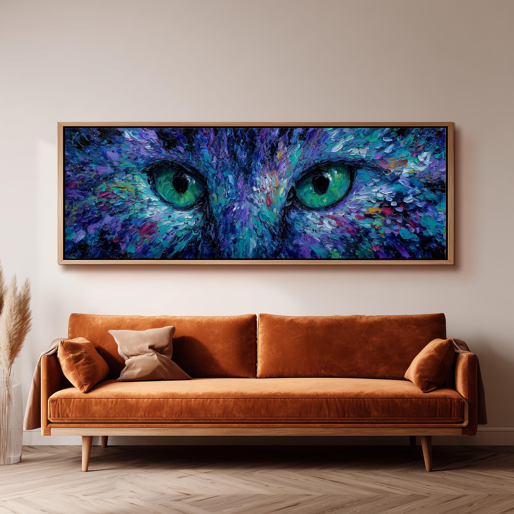 a large, vibrant painting of a cat's eyes, hanging on a wall above a brown sofa.