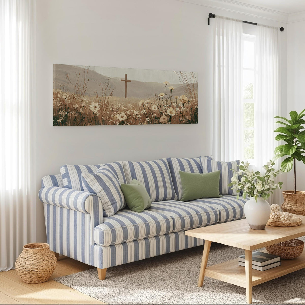 Wooden cross in a cream wildflower field long horizontal canvas print above a striped sofa in a coastal living room