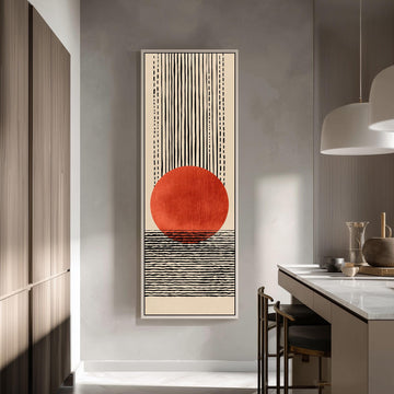 a modern kitchen with a large abstract painting hanging on the wall. The painting depicts a red circle with a black and white striped background, creating a striking visual contrast. The kitchen is well-lit, with a countertop and chairs visible, and a pendant light hanging above the countertop.